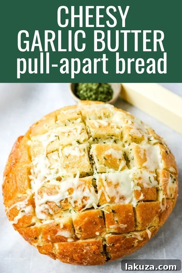 A single piece of cheesy pull-apart garlic bread, rich with melted cheese and fresh herbs, ready to be eaten