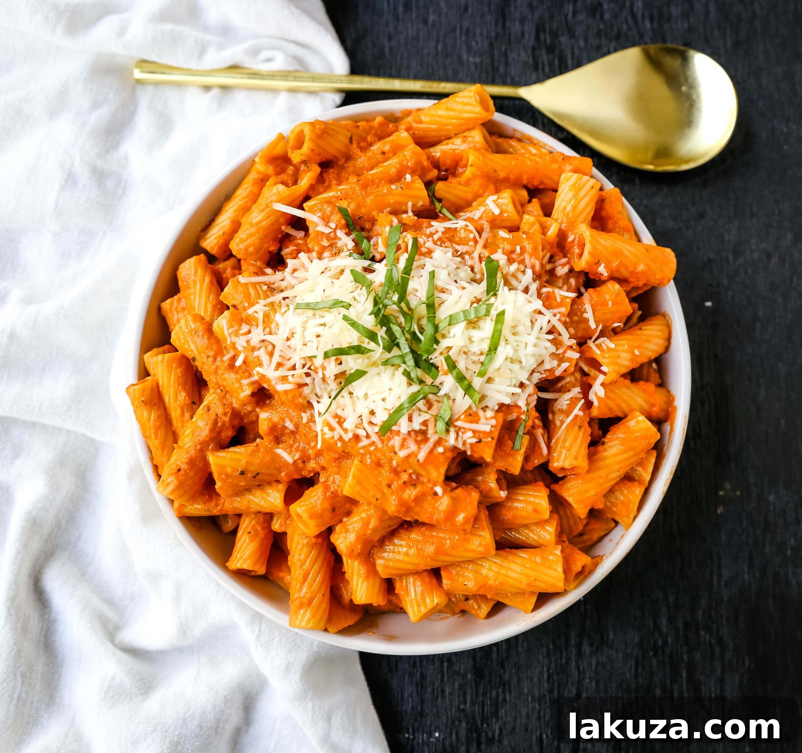 Creamy Roasted Red Pepper Pasta featuring a vibrant red sauce and fresh basil garnish.