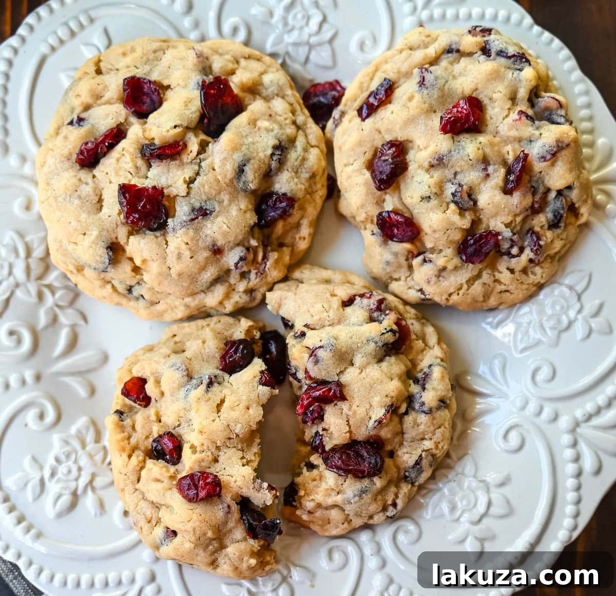Soft chewy brown sugar oatmeal cookies with sweetened dried cranberries. A chewy and hearty oatmeal cookie that everyone will love! These Cranberry Oatmeal Cookies always receive 5-star reviews. You will love these Oatmeal Cranberry Cookies!