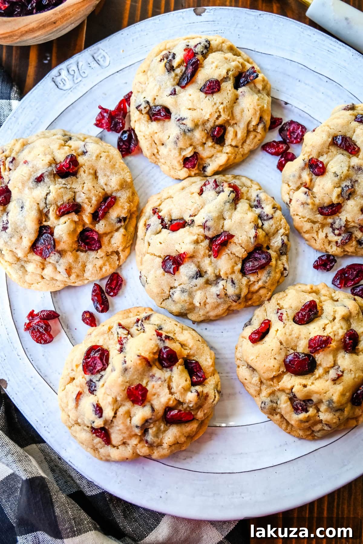 Soft chewy brown sugar oatmeal cookies with sweetened dried cranberries. A chewy and hearty oatmeal cookie that everyone will love! These Cranberry Oatmeal Cookies always receive 5-star reviews. You will love these Oatmeal Cranberry Cookies!