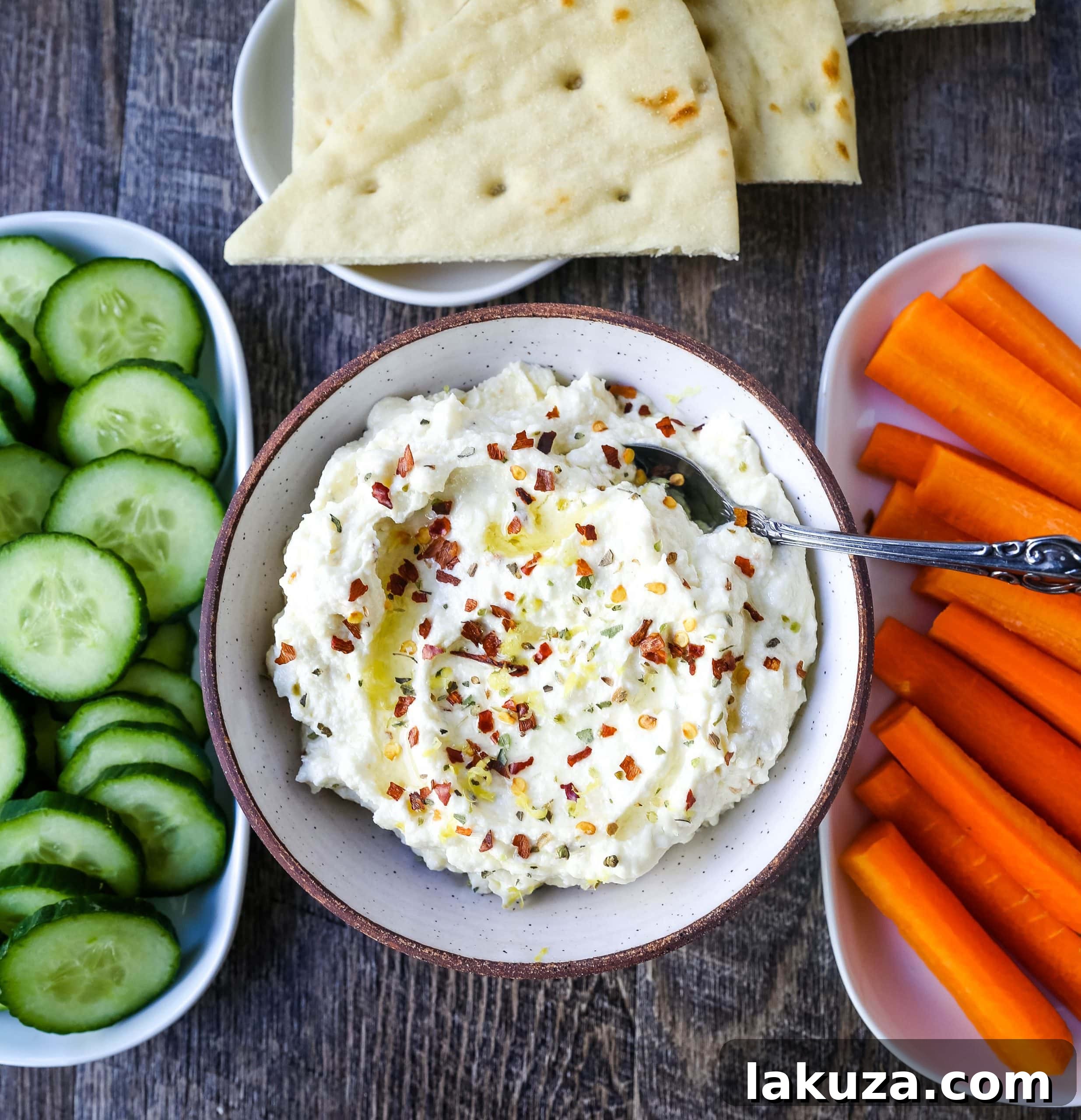 Mediterranean Creamy Feta Cheese Dip A creamy feta cheese dip with extra-virgin olive oil, feta cheese, cream cheese, garlic, fresh lemon zest, and red chili flakes. www.modernhoney.com #dip #dips #appetizer #appetizers #fetadip #fetacheesedip #superbowl