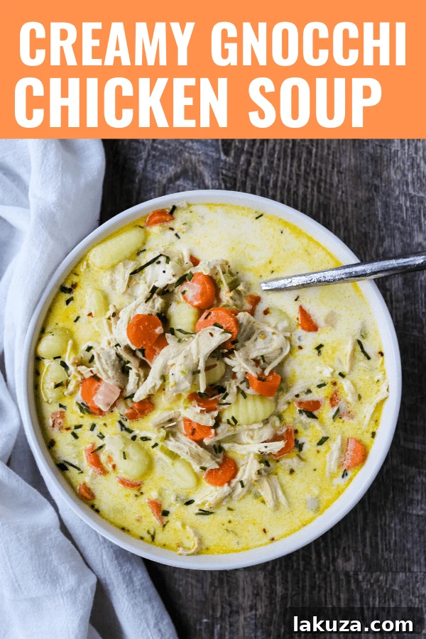 Large pot of creamy gnocchi chicken soup being stirred, showing rich texture and ingredients.