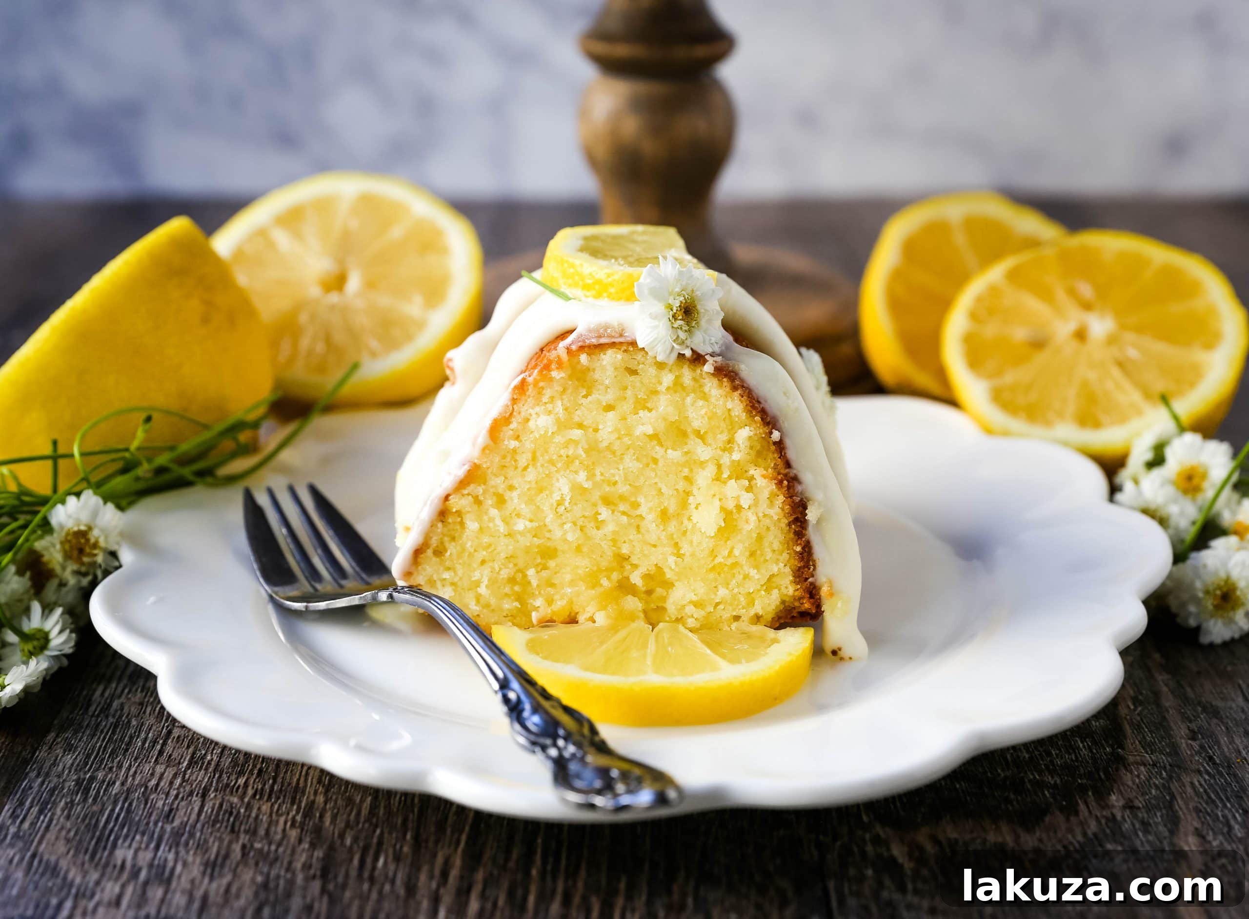 Close-up view of a slice of moist lemon bundt cake, revealing its tender crumb and rich texture.
