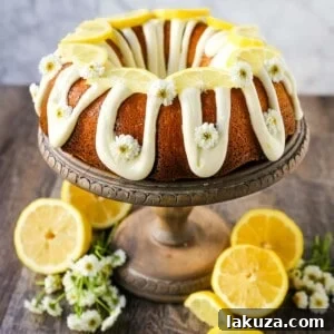 A generous slice of lemon bundt cake topped with a bright lemon cream cheese frosting.