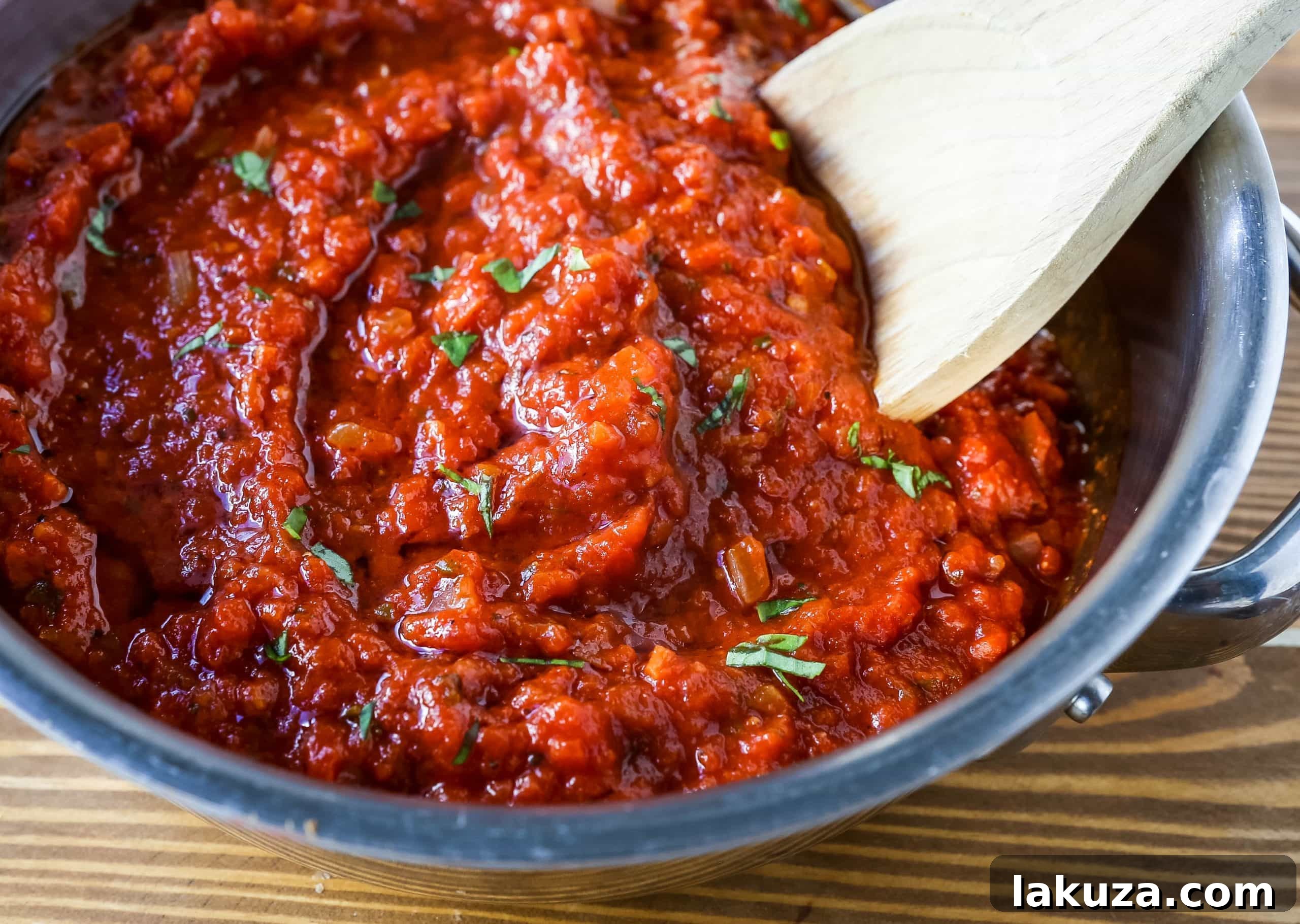 Grandma's Secret Tomato Recipe 3 Homemade marinara sauce simmering in a pot, showcasing its rich red color and fresh basil garnish. Ideal for spaghetti, lasagna, or chicken parmesan.