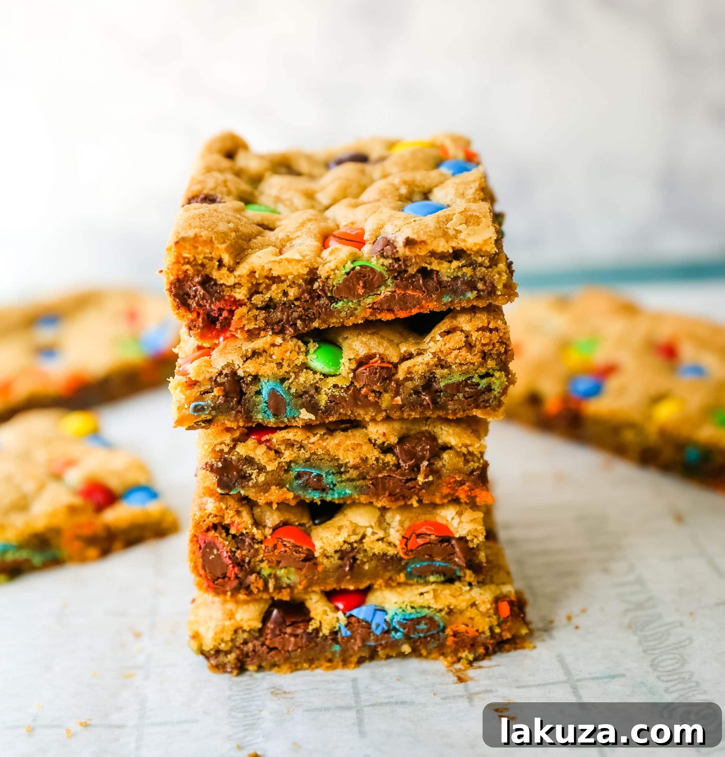 Close-up of M&M cookie bars showing colorful candies and gooey texture