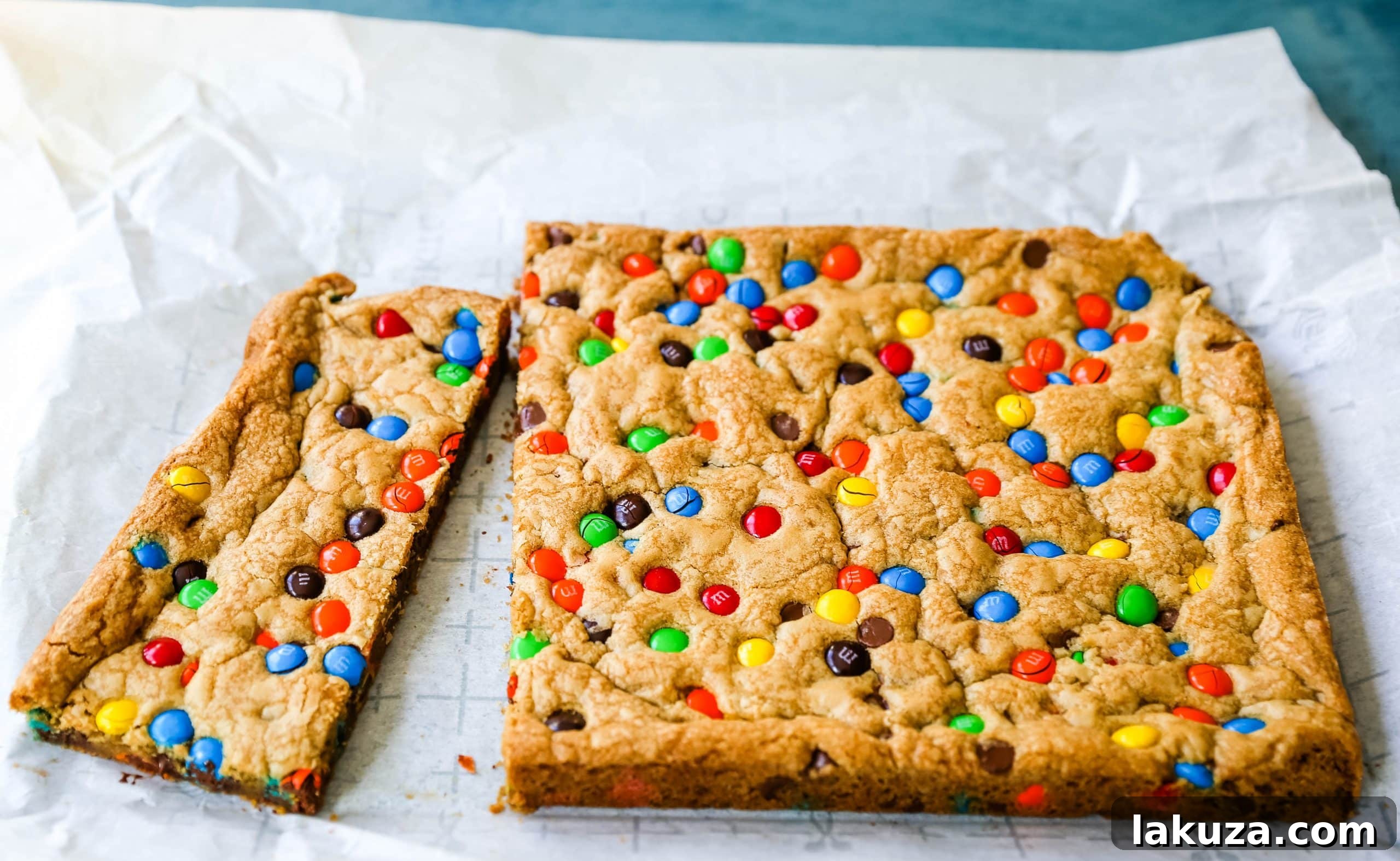 M&M cookie bars cooling on a wire rack, perfectly golden