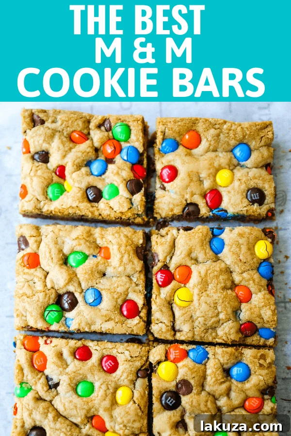 M&M cookie bar stacked on a plate, ready to be eaten