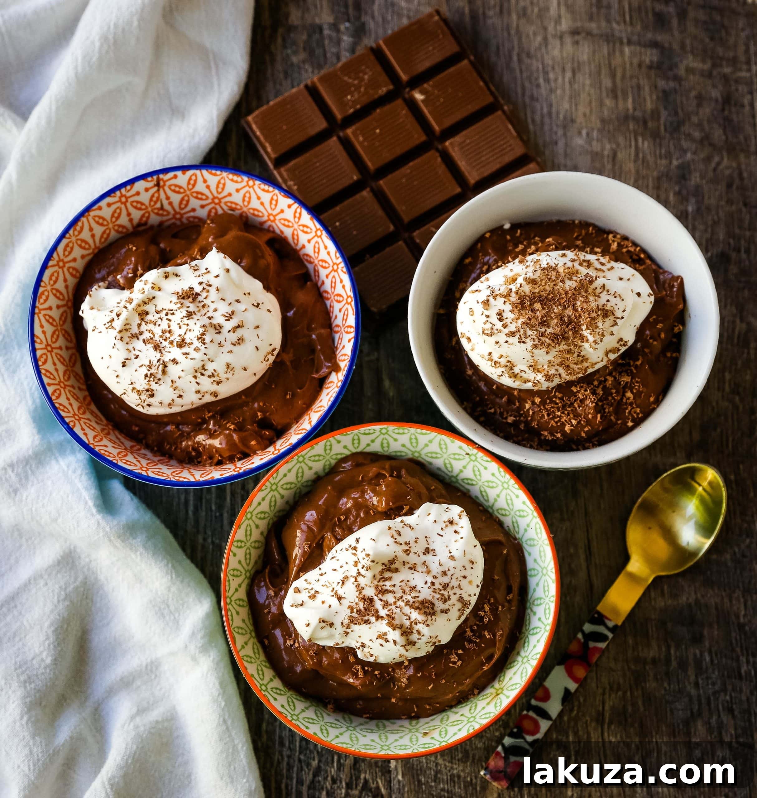 Smooth and creamy homemade chocolate pudding served in a clear glass bowl, showcasing its depth and inviting texture.