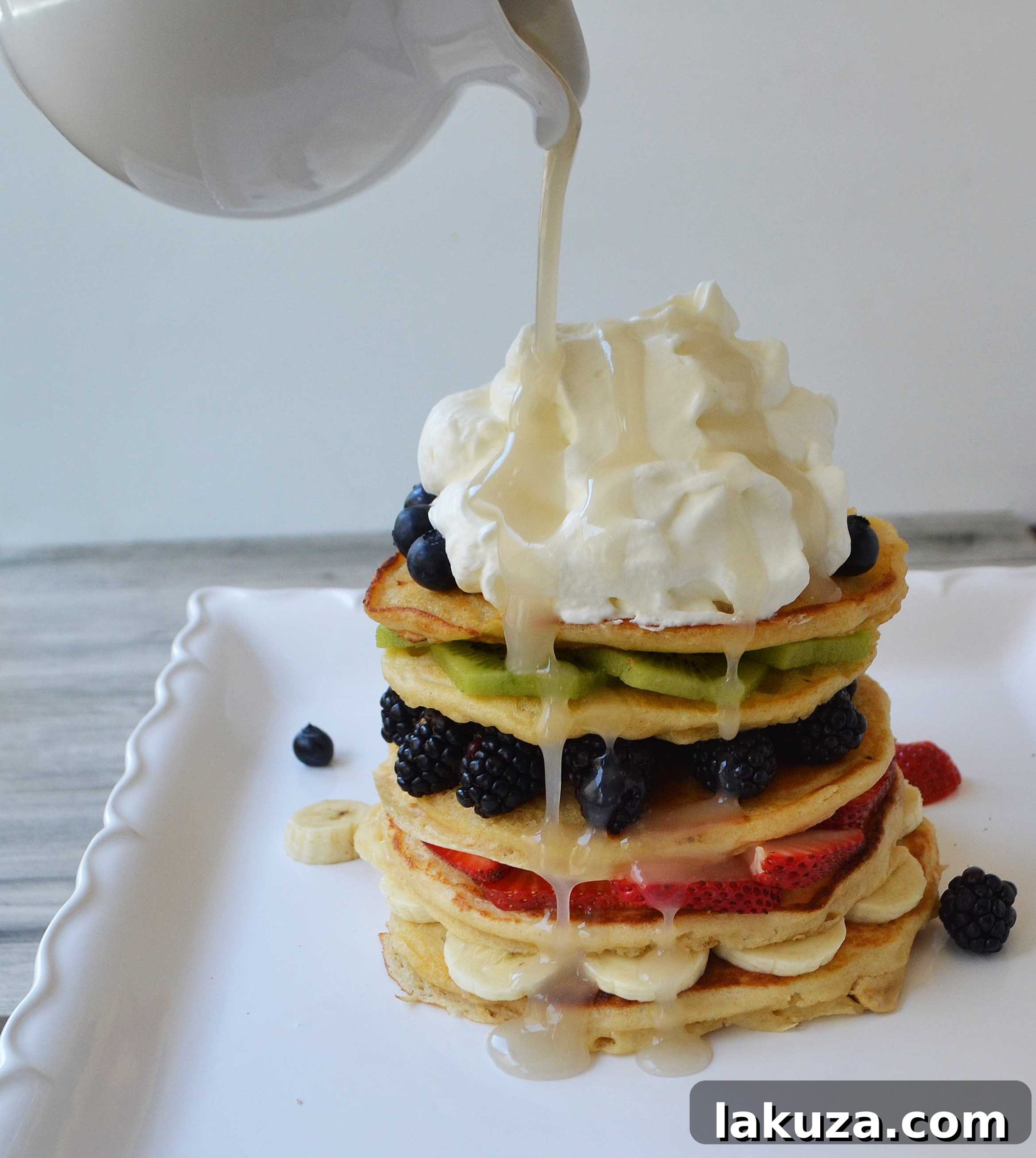 Delicious Fruit Pancake Stack with Coconut Syrup and Cream
