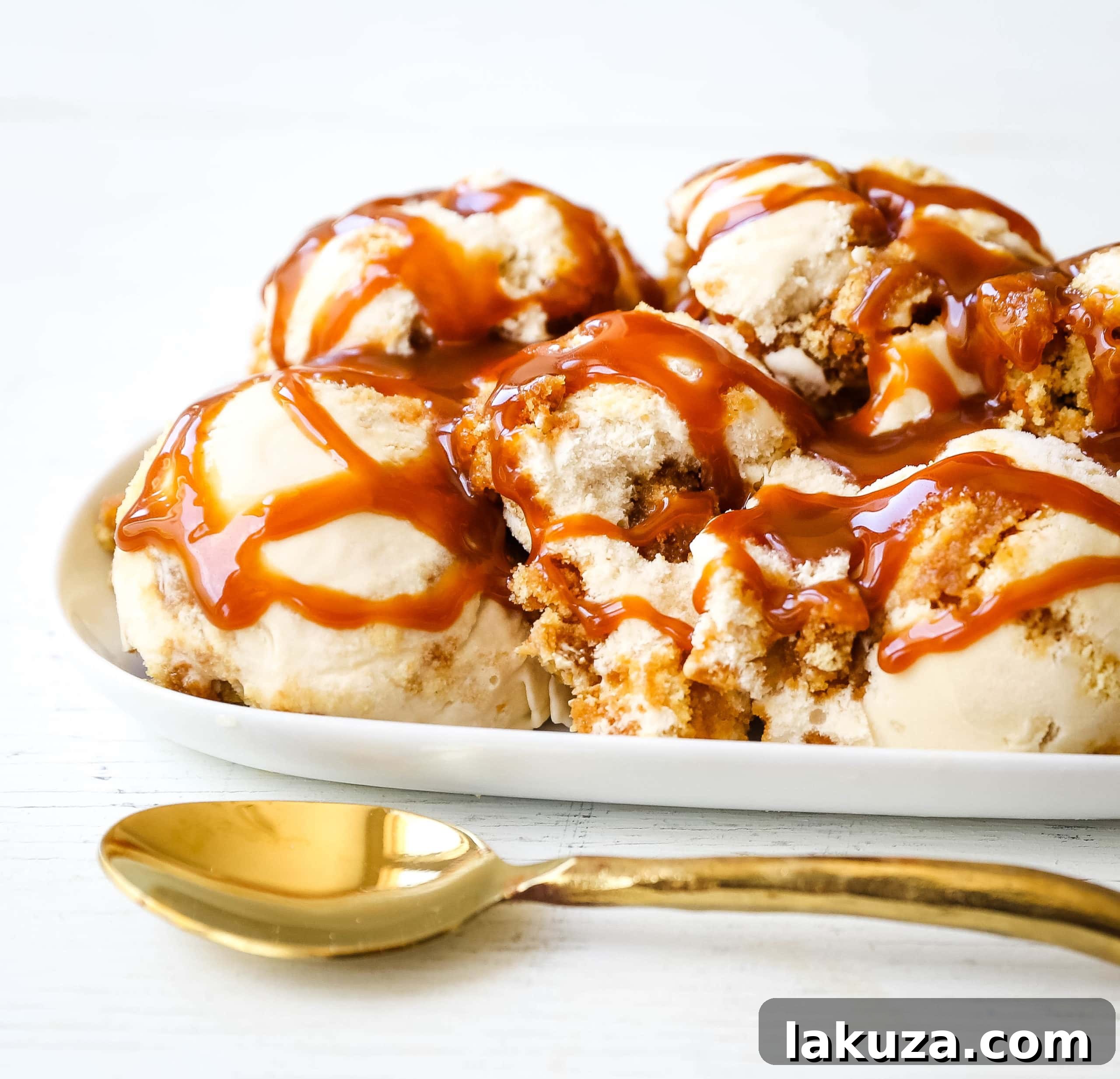 Decadent Caramel Gooey Butter Cake Ice Cream 5 A scoop of Caramel Gooey Butter Cake Ice Cream in a bowl, drizzled with extra caramel sauce, ready to be enjoyed.
