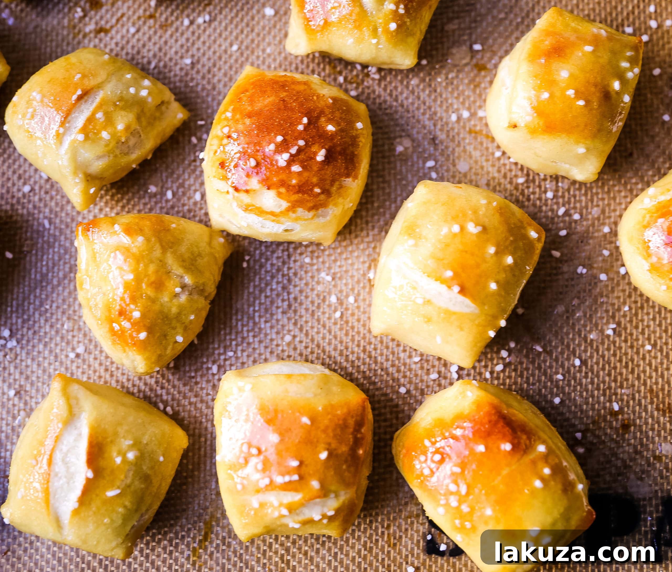 A vibrant flat lay of homemade pretzel bites, some covered in cinnamon sugar, some with coarse salt, showcasing delicious variety.
