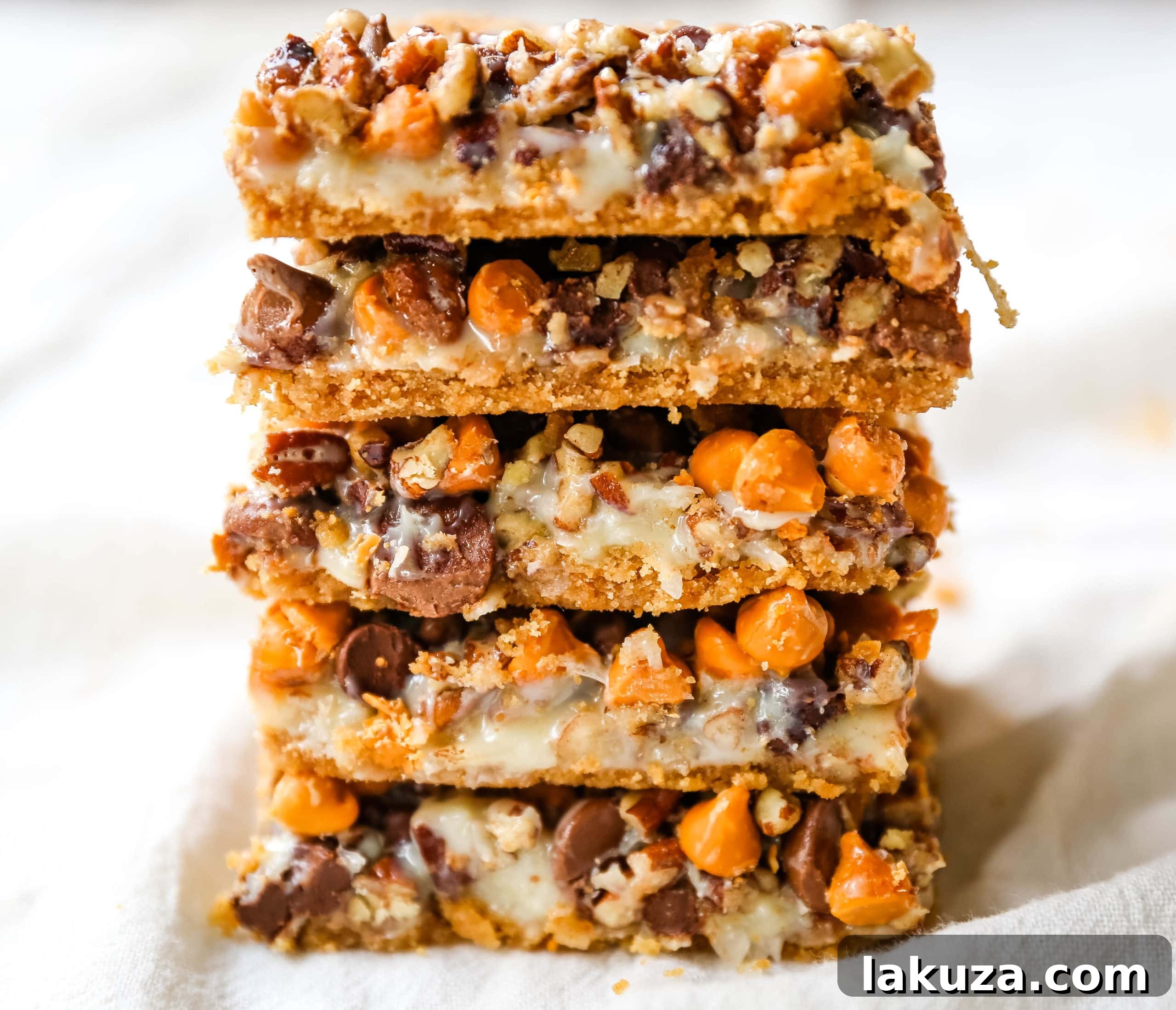 Decadent Seven-Layer Dream Bars 4 A tray of 7-Layer Magic Bars cooling, showing the dense, multi-layered texture ready for cutting.