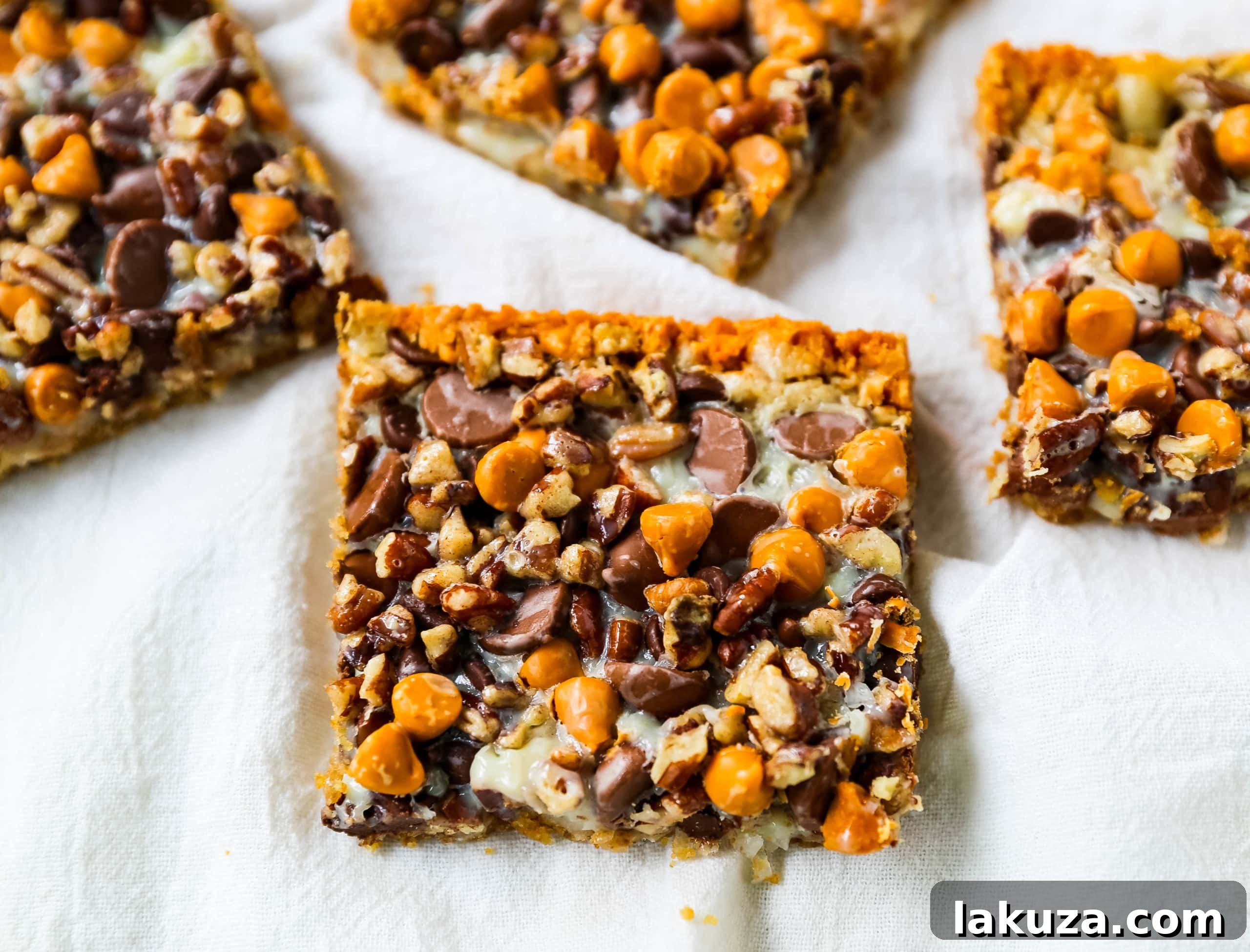 Decadent Seven-Layer Dream Bars 6 A serving of 7-Layer Magic Bars with a crisp, golden crust and melted chocolate on top.