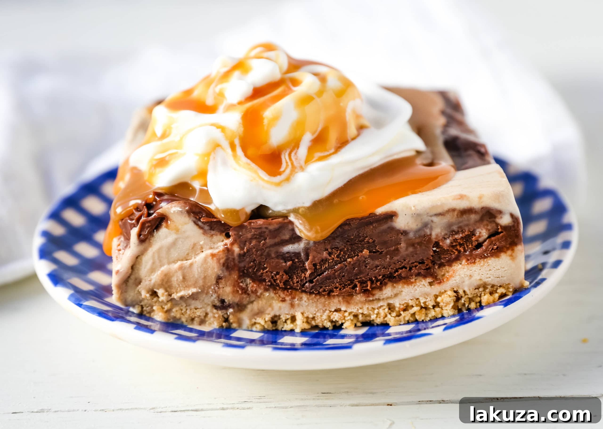 Chocolate Fudge Caramel Ice Cream Indulgence 3 Chocolate Fudge Caramel Ice Cream Dessert: A close-up view of a slice of the layered dessert, showcasing the crisp sugar cone crust, the smooth salted caramel ice cream, and the thick, glossy hot fudge layer. Perfectly garnished for a delightful treat. #icecream #icecreampie #icecreamdessert