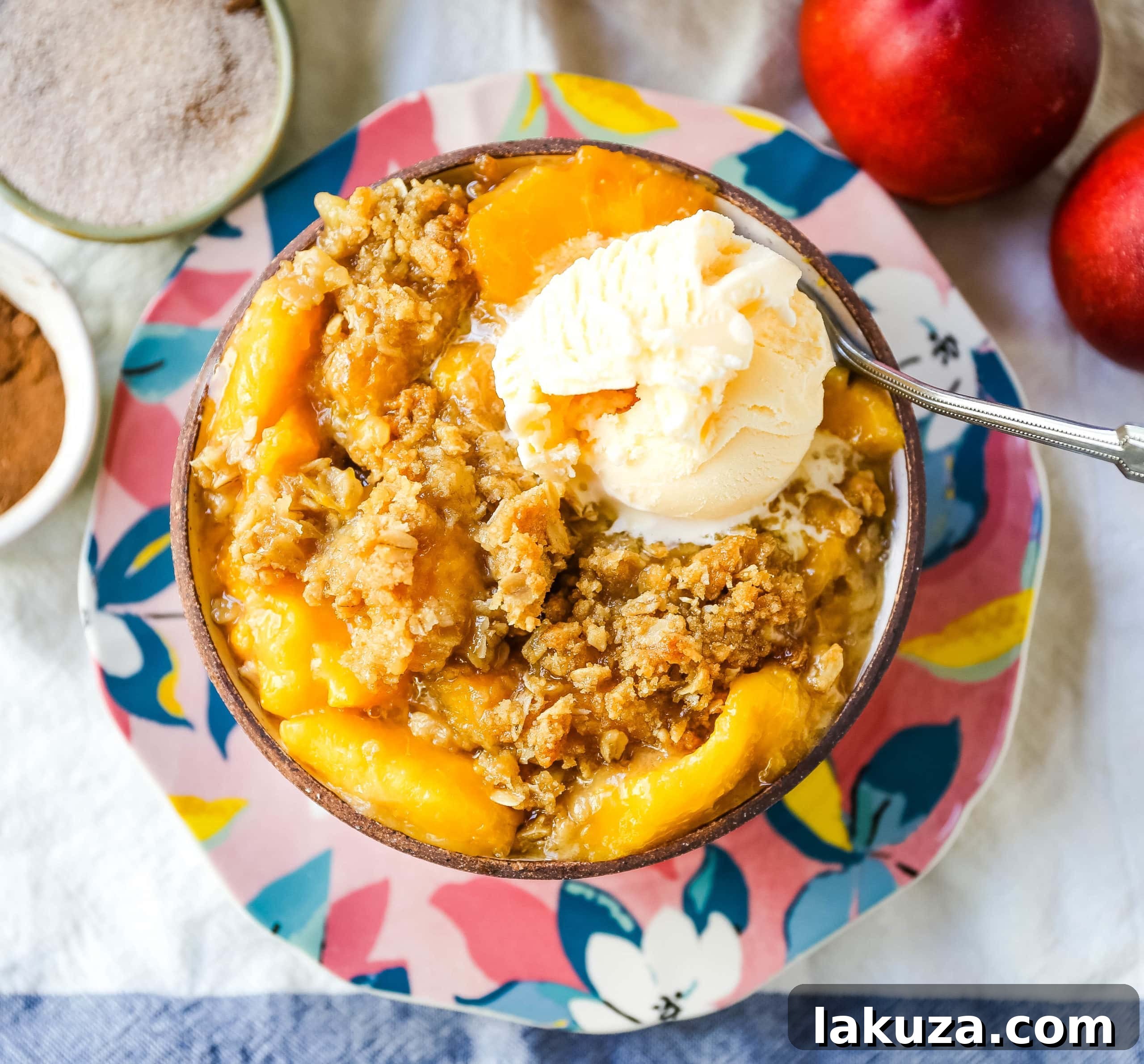 Golden Peach Delight 2 Peach Crisp: Fresh, sweetened peaches topped with a brown sugar oat crumble and vanilla ice cream. The ultimate summer dessert recipe. #peachcrisp #summerdessert #oatcrumble