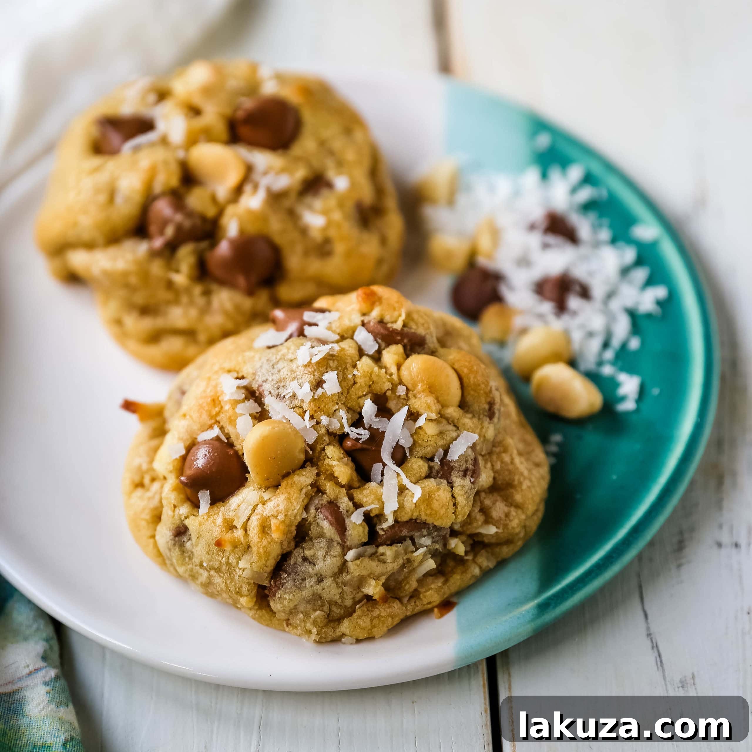 Irresistible Milk Chocolate Macadamia Coconut Cookies 5 A vibrant display of cookie dough balls, studded with milk chocolate chips, macadamia nuts, and coconut flakes, ready for baking.