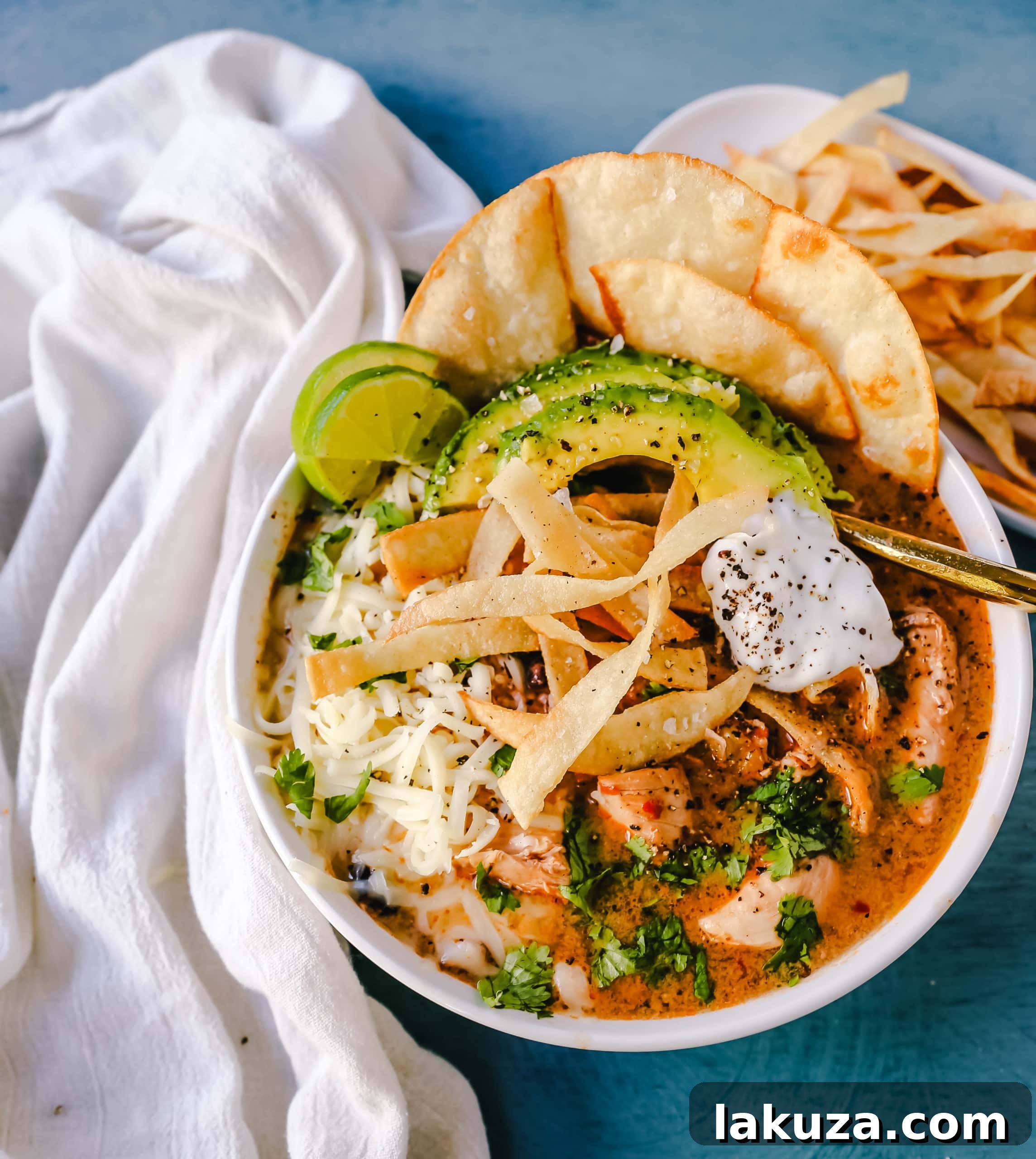 Creamy Slow Cooker Chicken Tortilla Soup 4 A beautifully plated bowl of slow cooker creamy chicken tortilla soup with fresh toppings.