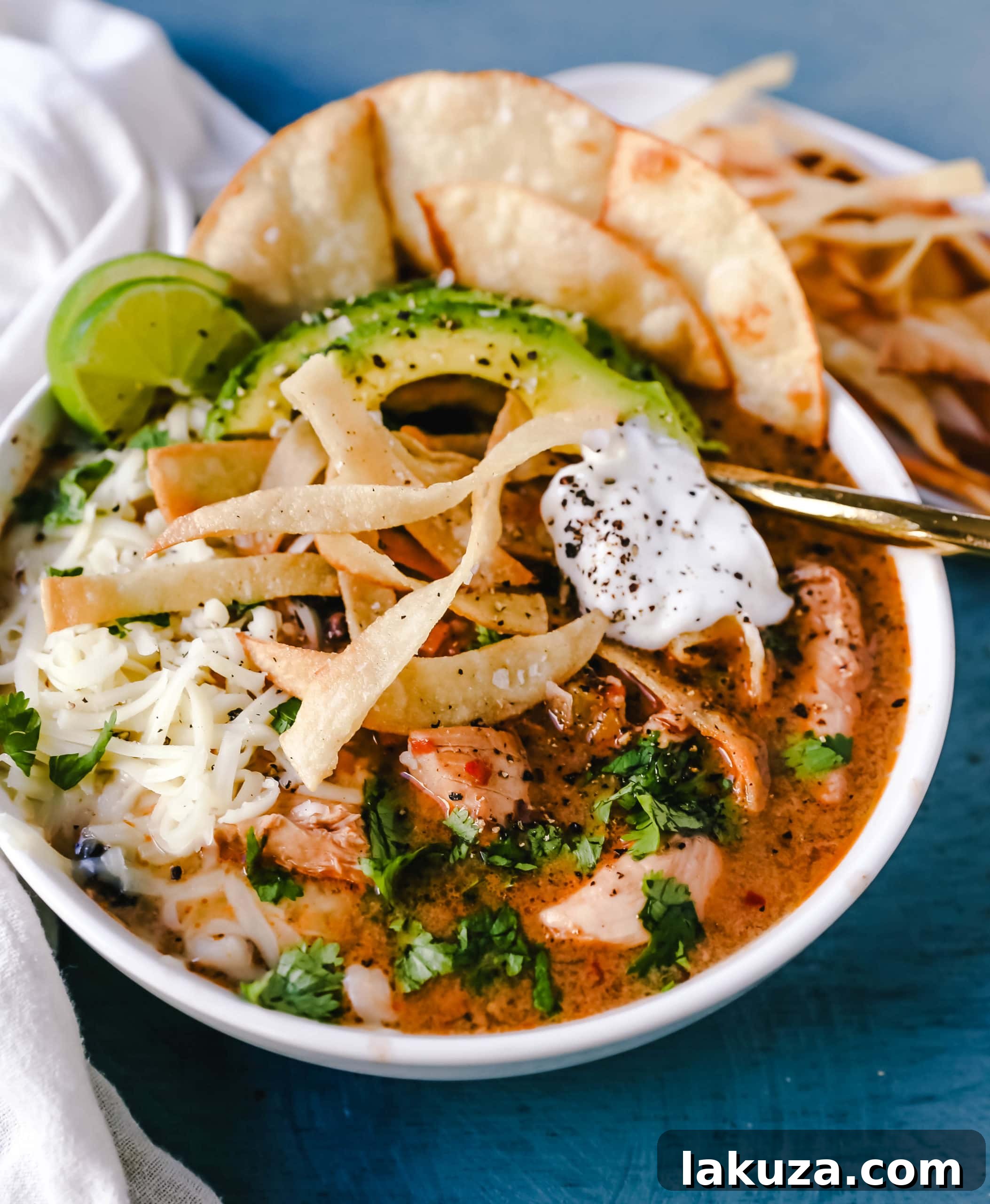 Creamy Slow Cooker Chicken Tortilla Soup 5 Assorted toppings for slow cooker creamy chicken tortilla soup, including avocado and cilantro.