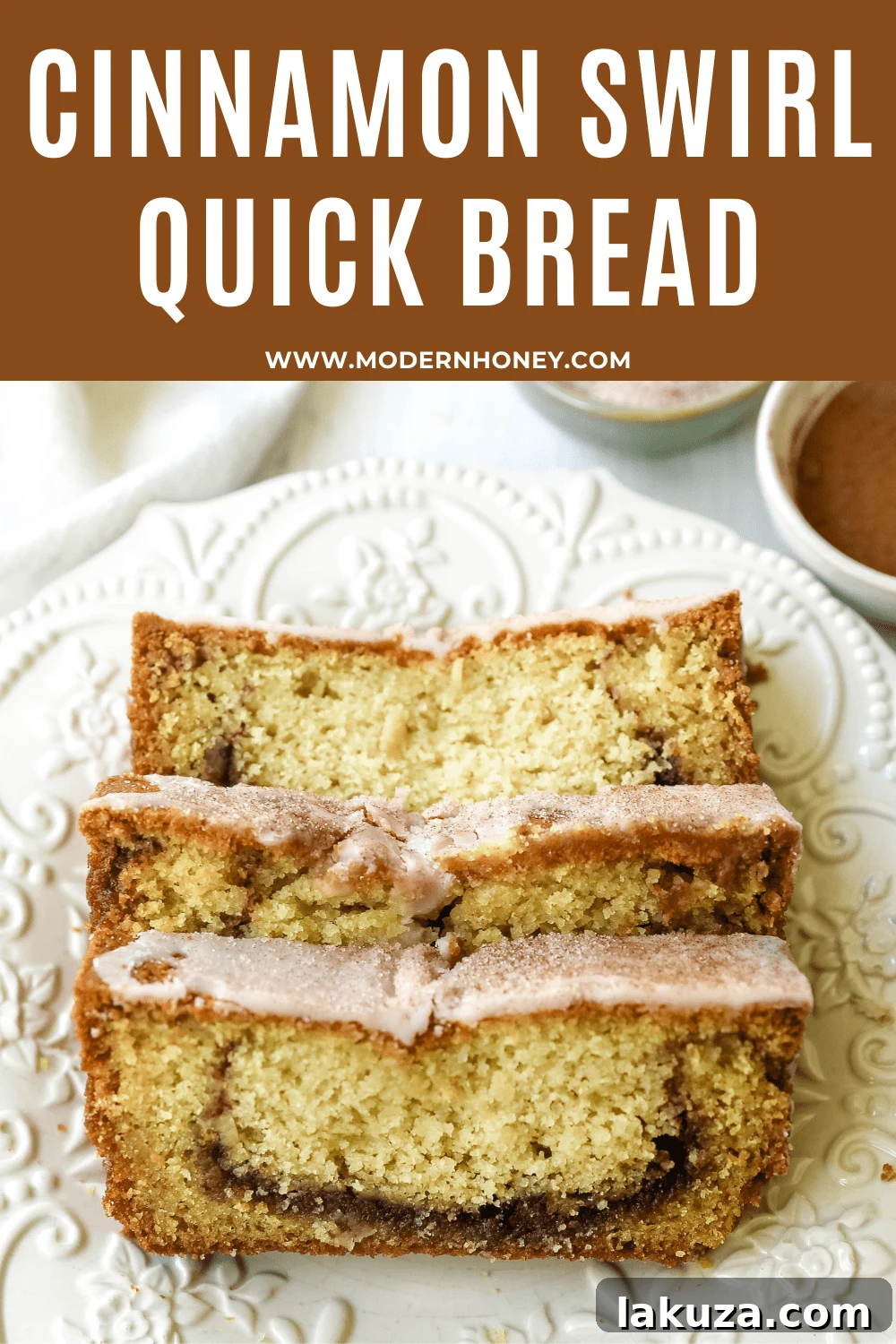 A slice of Cinnamon Swirl Quick Bread showing the tender crumb and icing