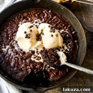 Double Chocolate Chip Skillet Cookie ready to be served with ice cream.