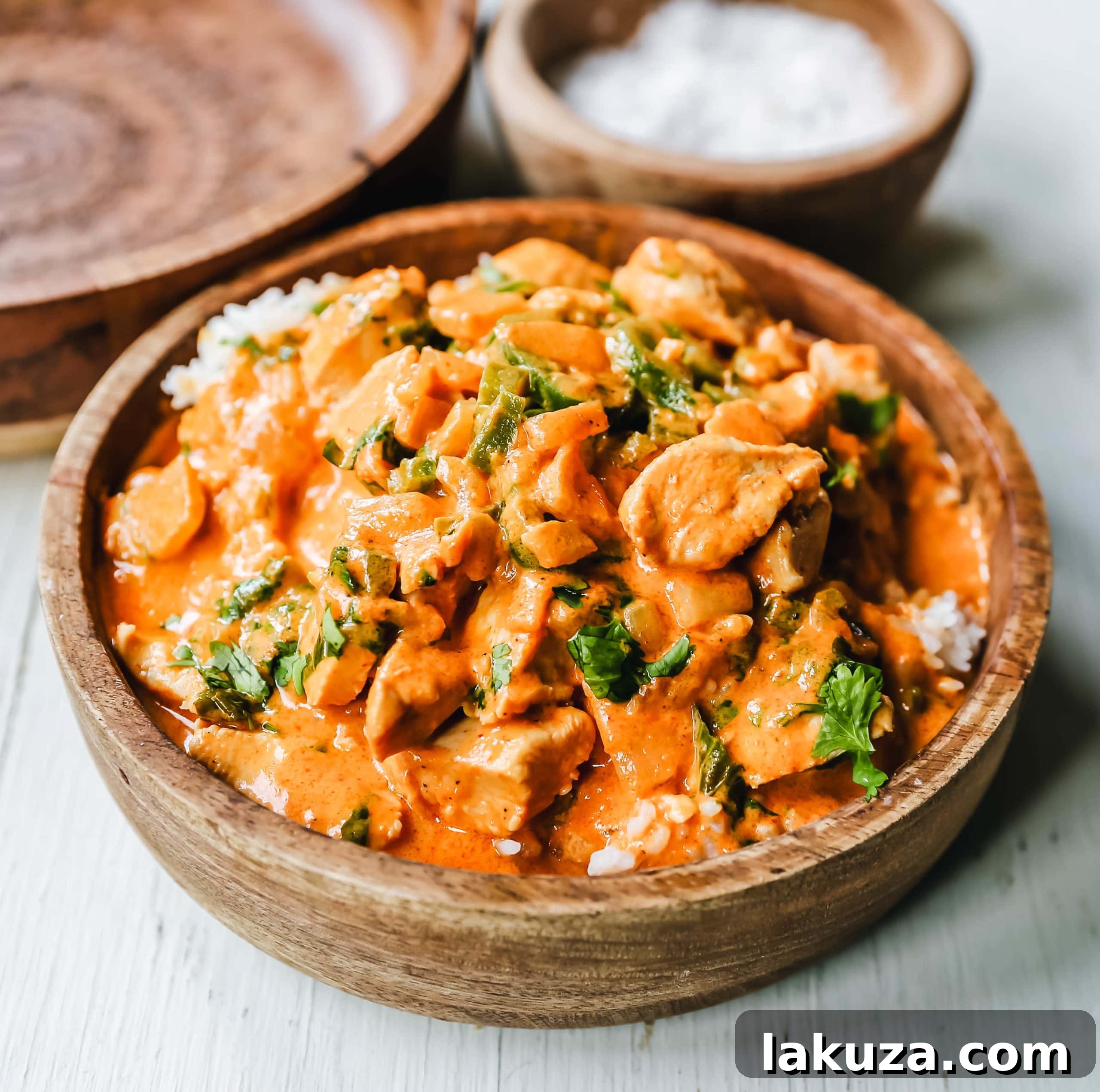 Authentic Thai Red Chicken Curry 2 Rich and creamy homemade Thai Red Chicken Curry served in a white bowl, garnished with fresh cilantro, ready to be enjoyed. Better than any restaurant takeout!
