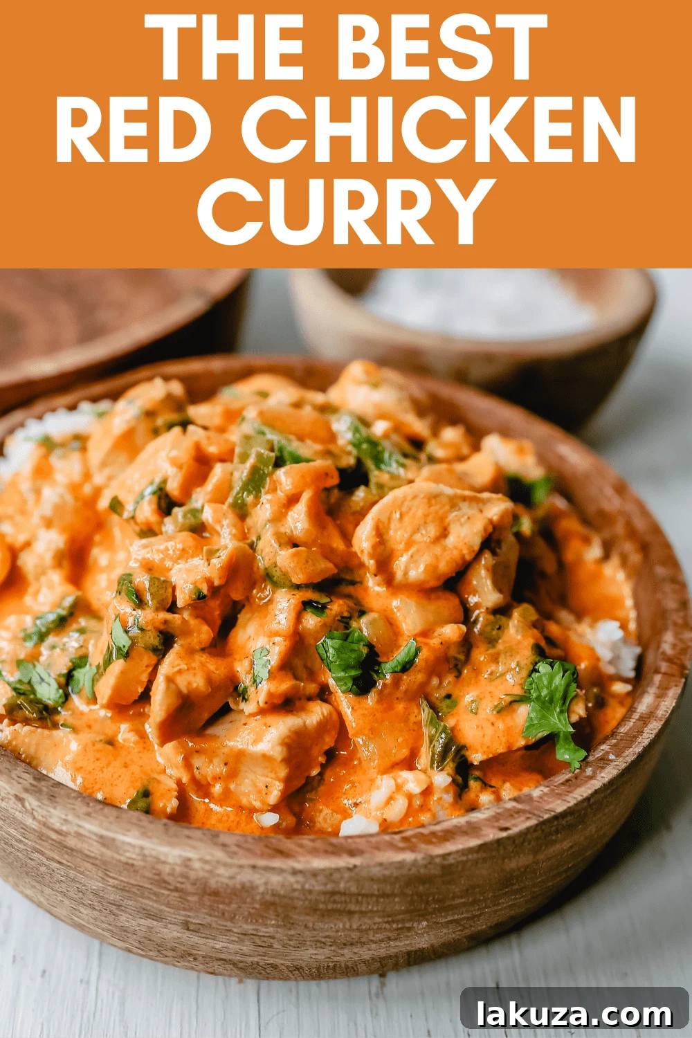 Authentic Thai Red Chicken Curry 5 A vibrant and fresh serving of homemade Thai Red Chicken Curry, garnished with bright green Thai basil, ready to be enjoyed with rice.