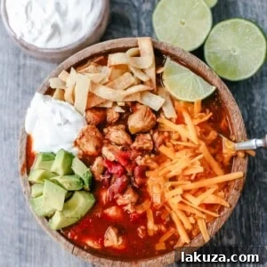 Traditional, homemade chicken chili with Mexican spices, green chilies, tomatoes, chili beans, and two secret ingredients to put it over the top!