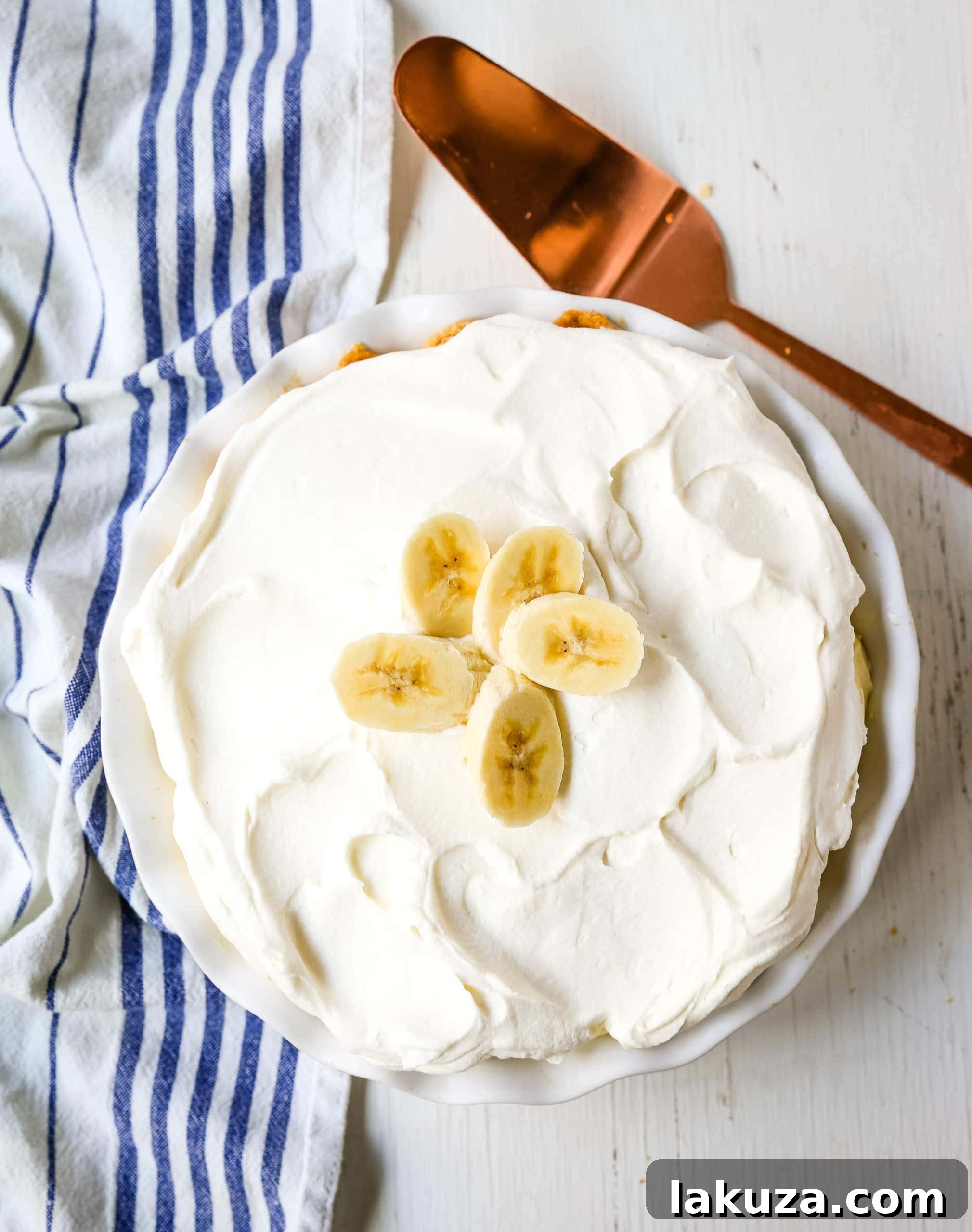 A delicious homemade banana cream pie with a creamy vanilla filling, fresh bananas, and fluffy whipped cream, perfect for sharing.