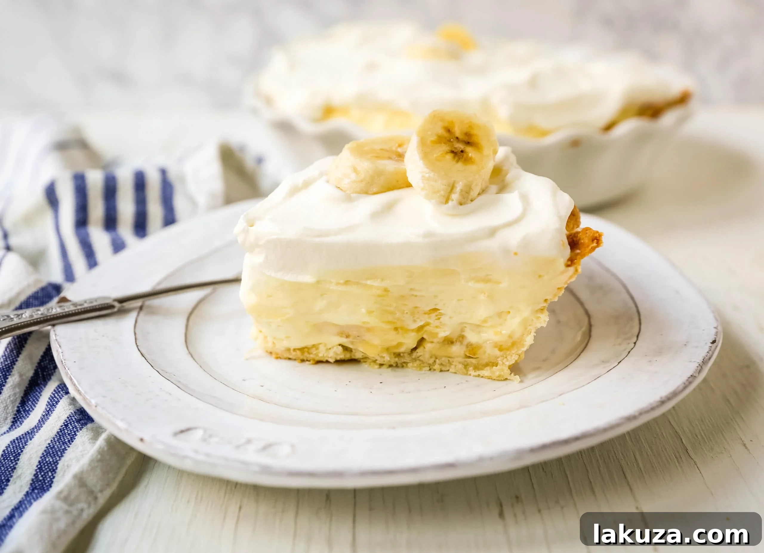 A homemade banana cream pie prepared with care, featuring a creamy filling, fresh bananas, and fluffy whipped cream, presented beautifully.