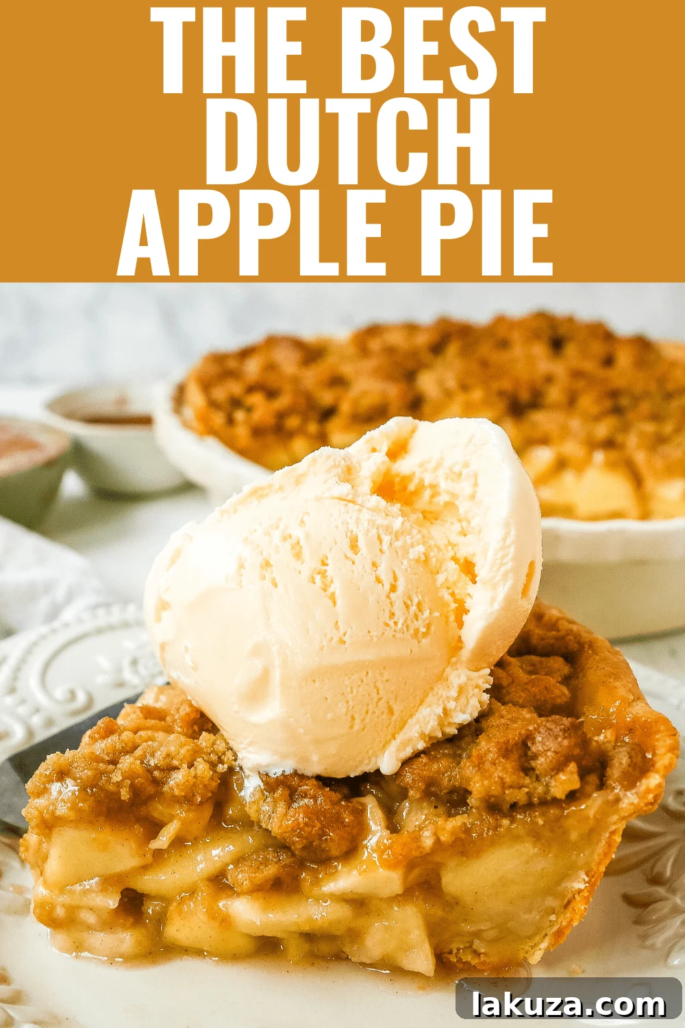 Authentic Dutch Apple Crumble 8 Warm slice of Dutch apple pie on a white plate, ready to be enjoyed.