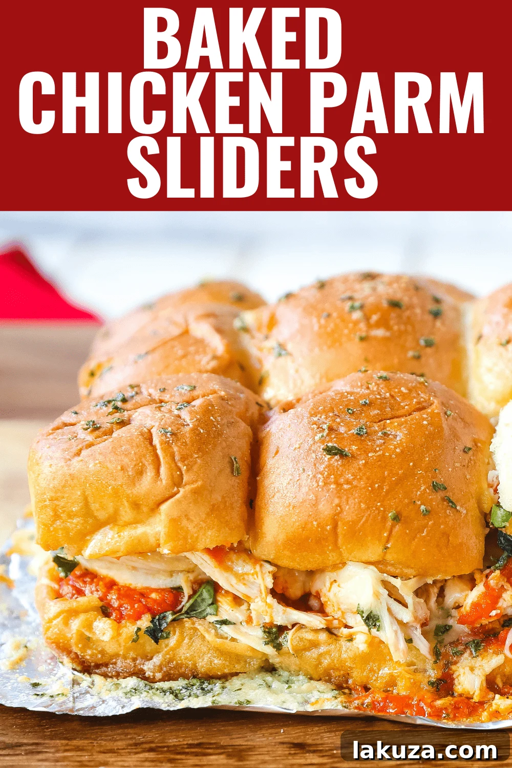 Hot and gooey Baked Chicken Parm Sliders, fresh from the oven, with melted cheese and a golden garlic butter crust, ready to be devoured.