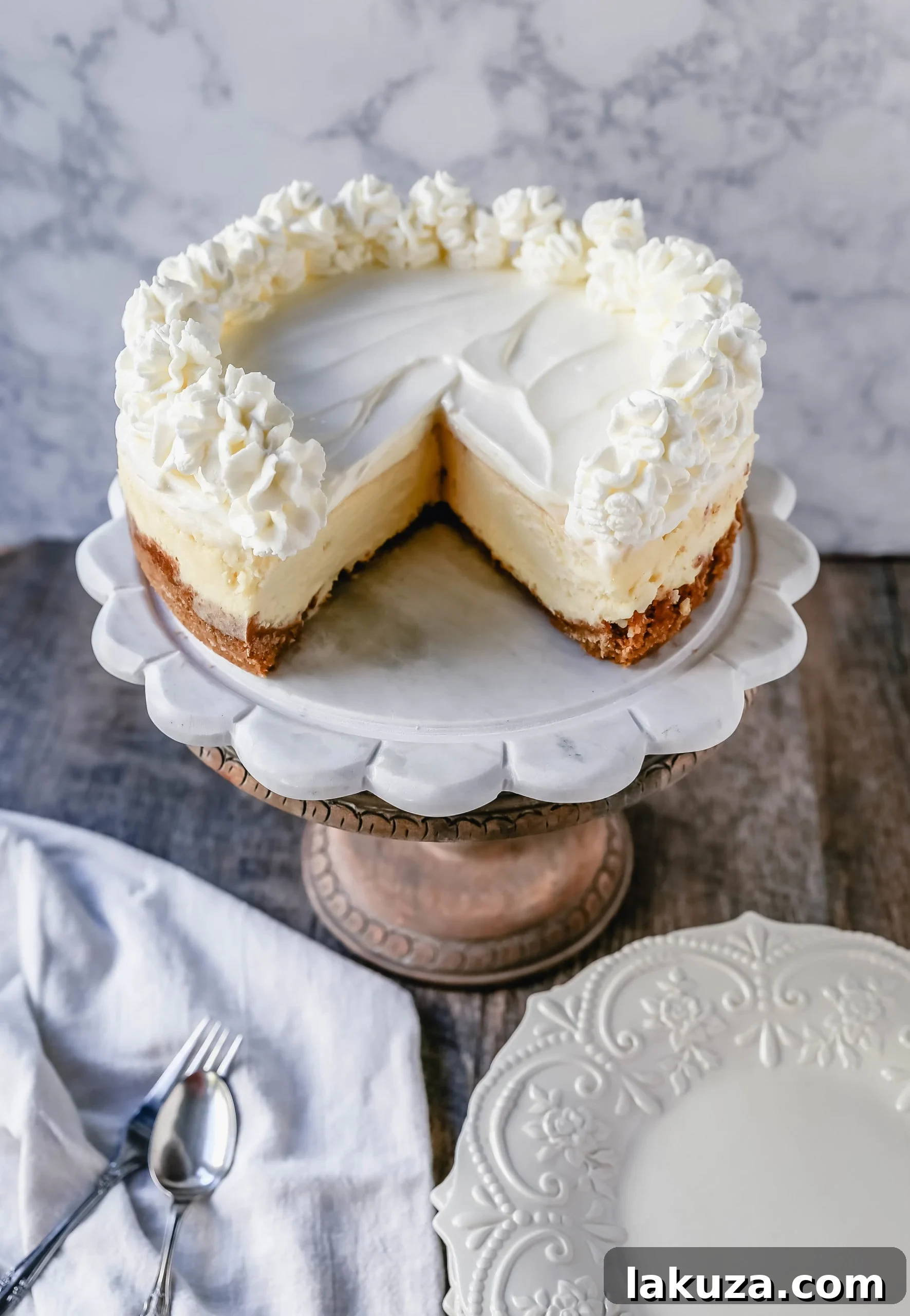 Vanilla Bean Cheesecake 4 The Best Cheesecake Recipe: How to make the creamiest, dreamiest, richest vanilla cheesecake with a buttery graham cracker crust. All of the tips and tricks for making the perfect cheesecake! www.modernhoney.com #cheesecake #vanillacheesecake #cheesecakerecipe #dessert