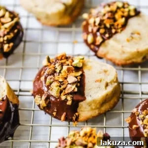 Chocolate-Dipped Pistachio Shortbread Cookies with orange zest, ideal for festive occasions.