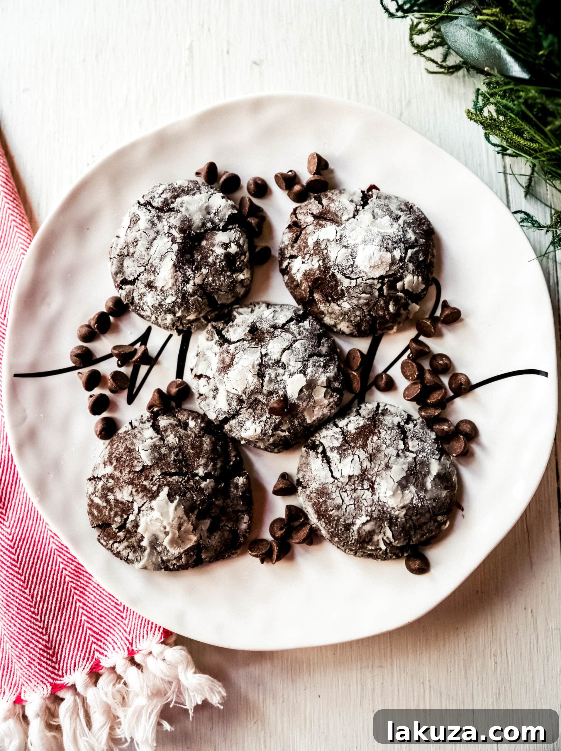Close-up of freshly baked Chocolate Crinkle Cookies, showcasing their distinct powdered sugar coating and rich chocolate texture.