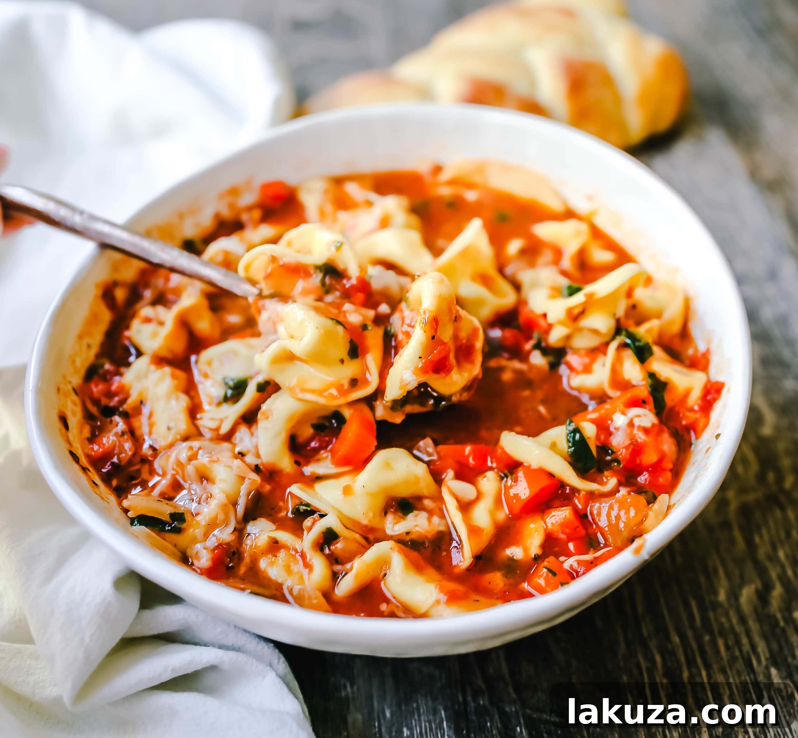 Wholesome Garden Tortellini Soup 4 Freshly grated Parmesan cheese topping a bowl of Tuscan Tortellini Vegetable Soup