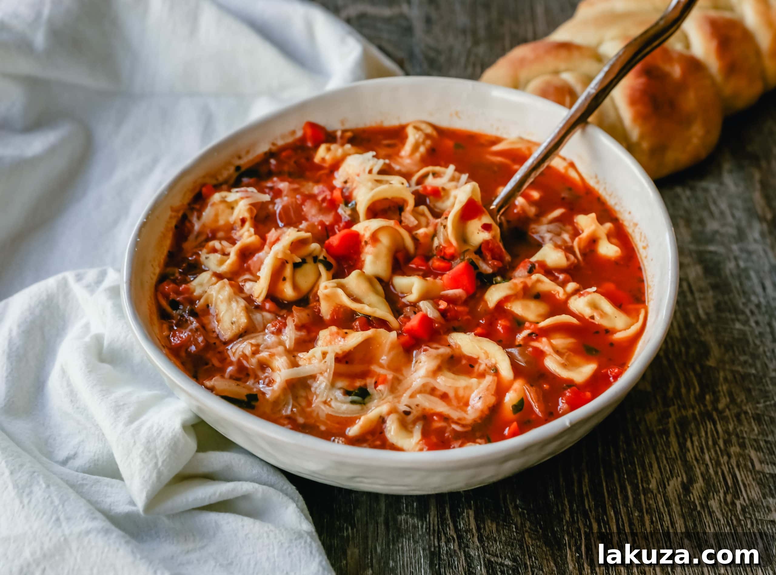 Wholesome Garden Tortellini Soup 6 A beautiful top-down view of Tuscan Tortellini Vegetable Soup in a bowl