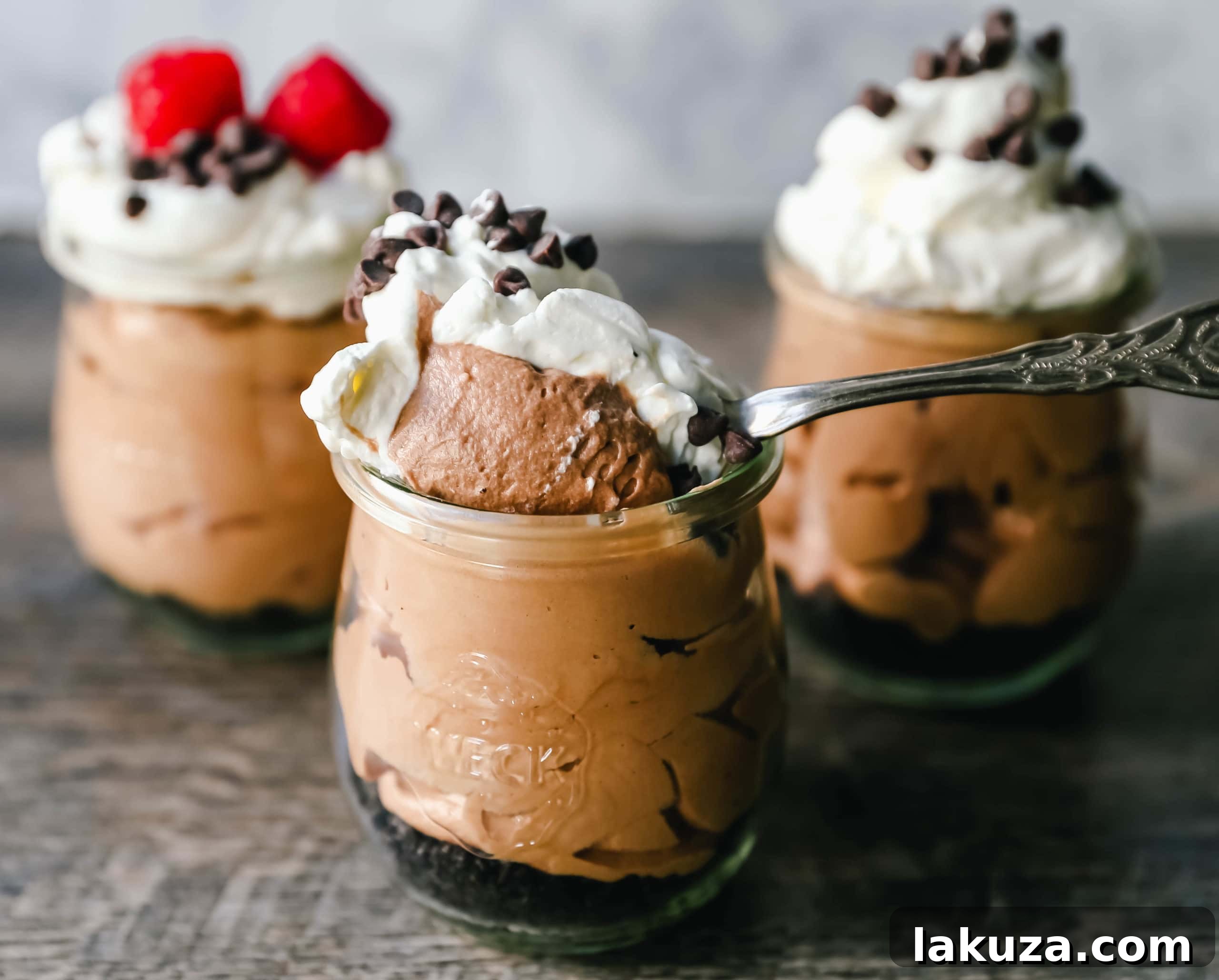 Chocolate Nutella Cheesecake Mousse, a no-bake dessert crafted with Nutella, cream cheese, heavy cream, and powdered sugar, showcased in a elegant dessert glass with layers. This 5-minute recipe is an easy and delicious treat for any occasion. #dessertrecipe #quickdessert #chocolatehazelnut #modernhoney