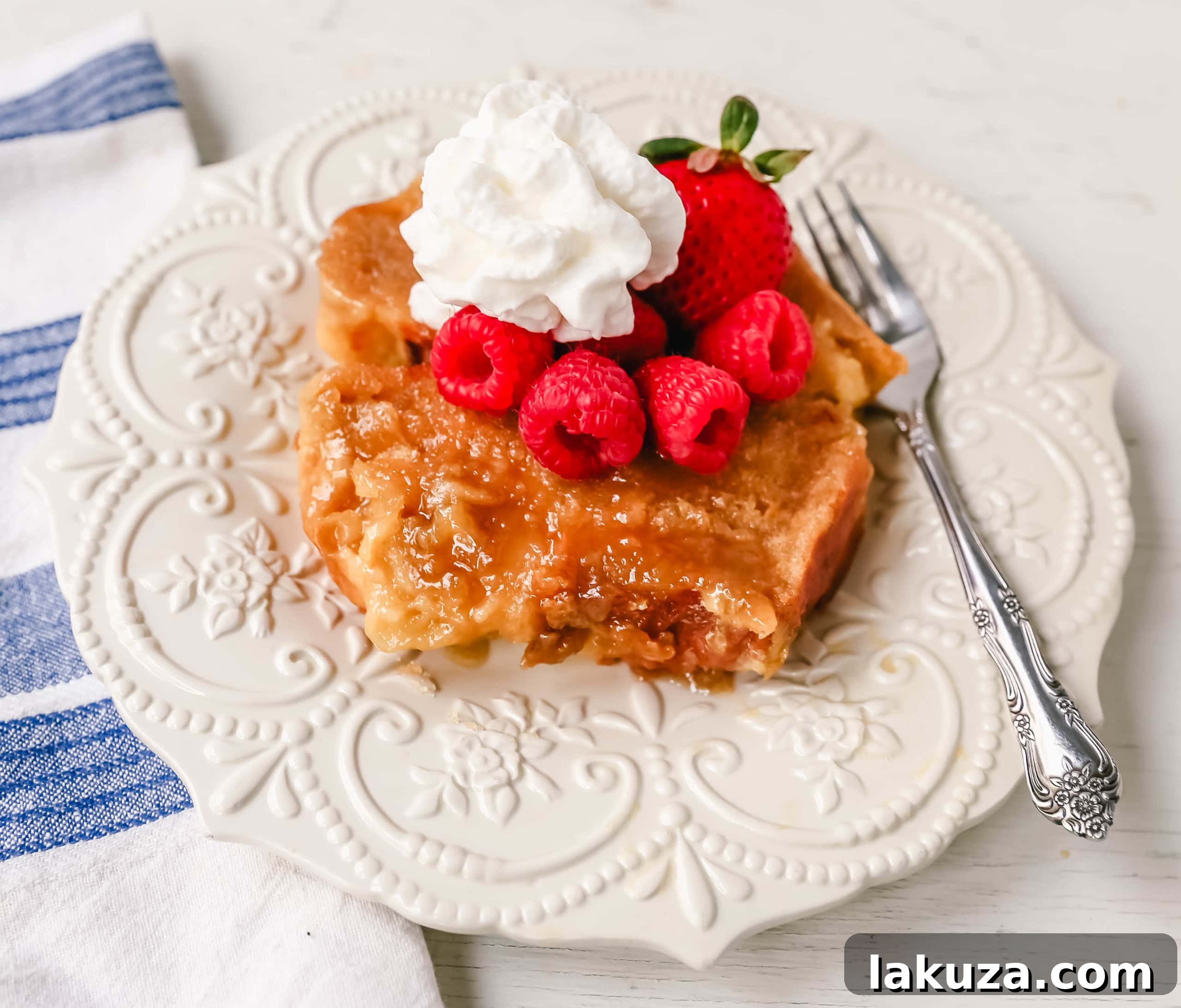 Make-Ahead Creme Brûlée French Toast Bake 3 Close-up of golden Overnight Creme Brulee French Toast in a baking dish, with a hint of the caramelized bottom, ready to be served for brunch.
