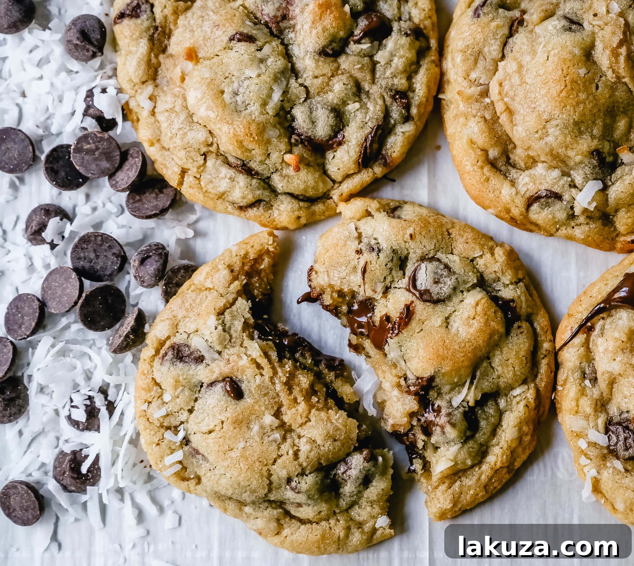 Tropical Chocolate Chip Coconut Cookies 3 Close-up of freshly baked chocolate chip coconut cookies on a cooling rack, showcasing melted chocolate chips and toasted coconut flakes for a perfect balance of flavor and texture.