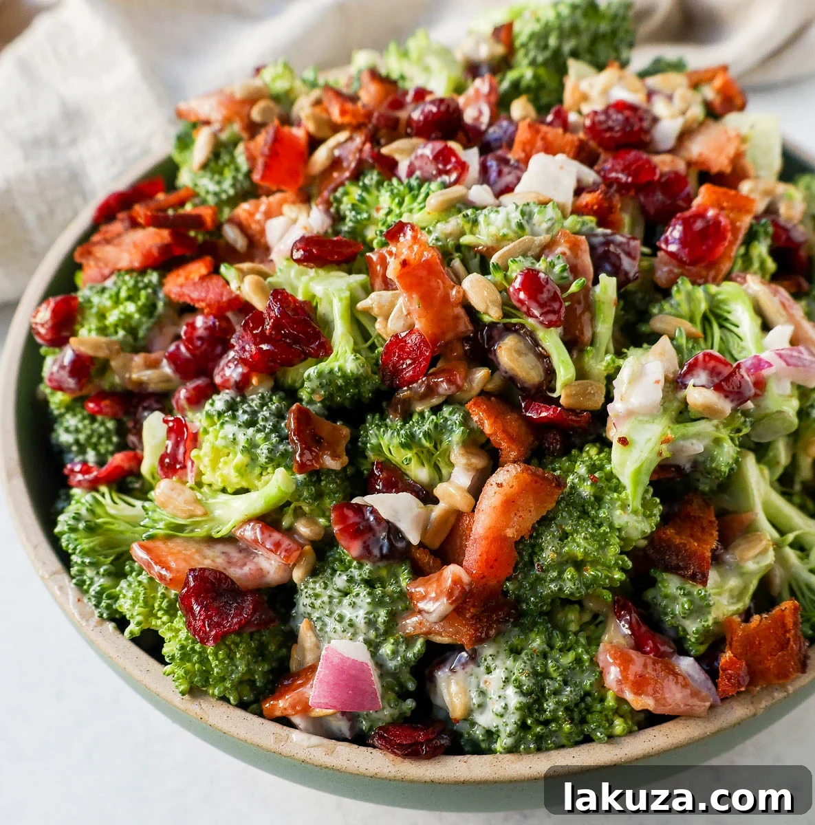 Crunchy, easy broccoli salad with crispy bacon, sweet dried cranberries, onion, and nuts all tossed in a sweet and tangy dressing. Tips for making the best broccoli salad. A classic potluck, BBQ, or summer side dish recipe!
