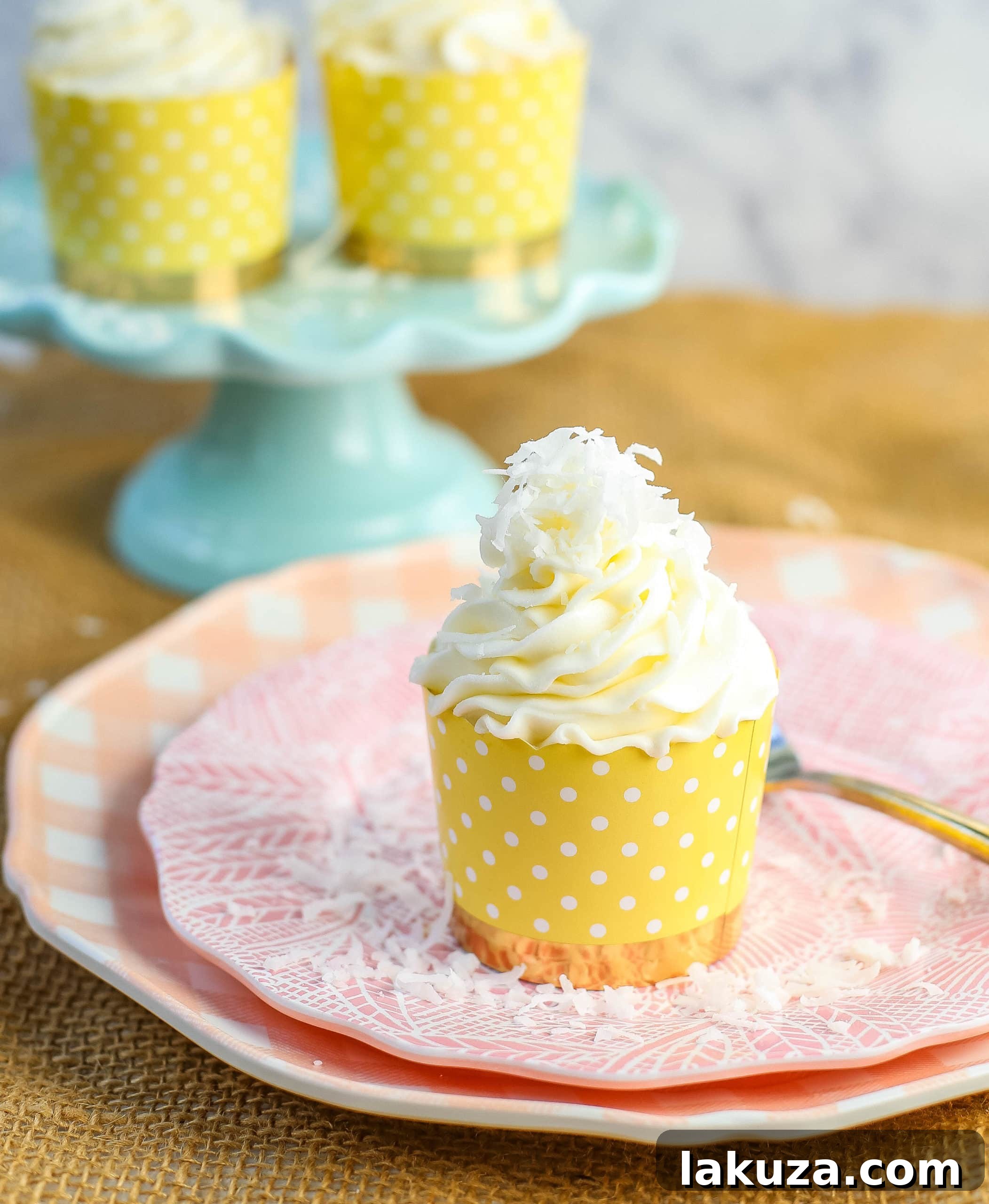 Deliciously moist coconut cupcakes with fluffy coconut cream cheese frosting, garnished with shredded coconut.
