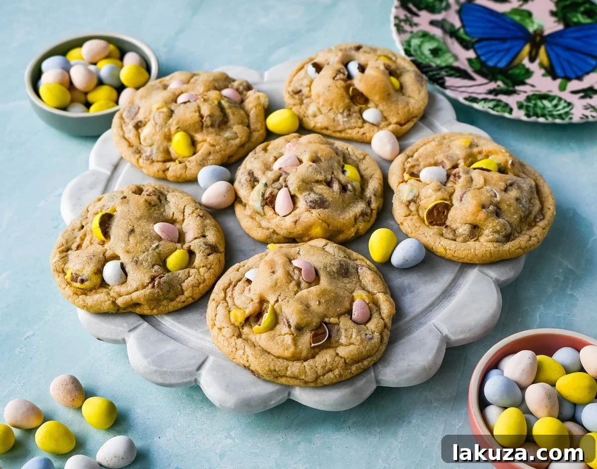 Close-up of baked Cadbury Egg Cookies, showcasing the mini chocolate Cadbury eggs embedded in the soft cookie dough.