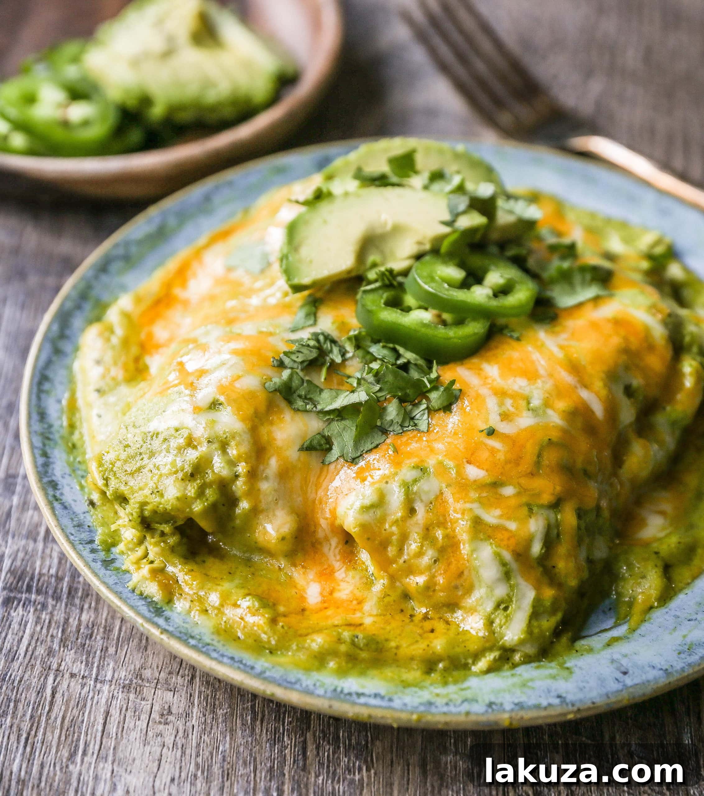 Close-up of creamy tomatillo-poblano sauce with roasted vegetables ready for blending, highlighting the fresh ingredients.