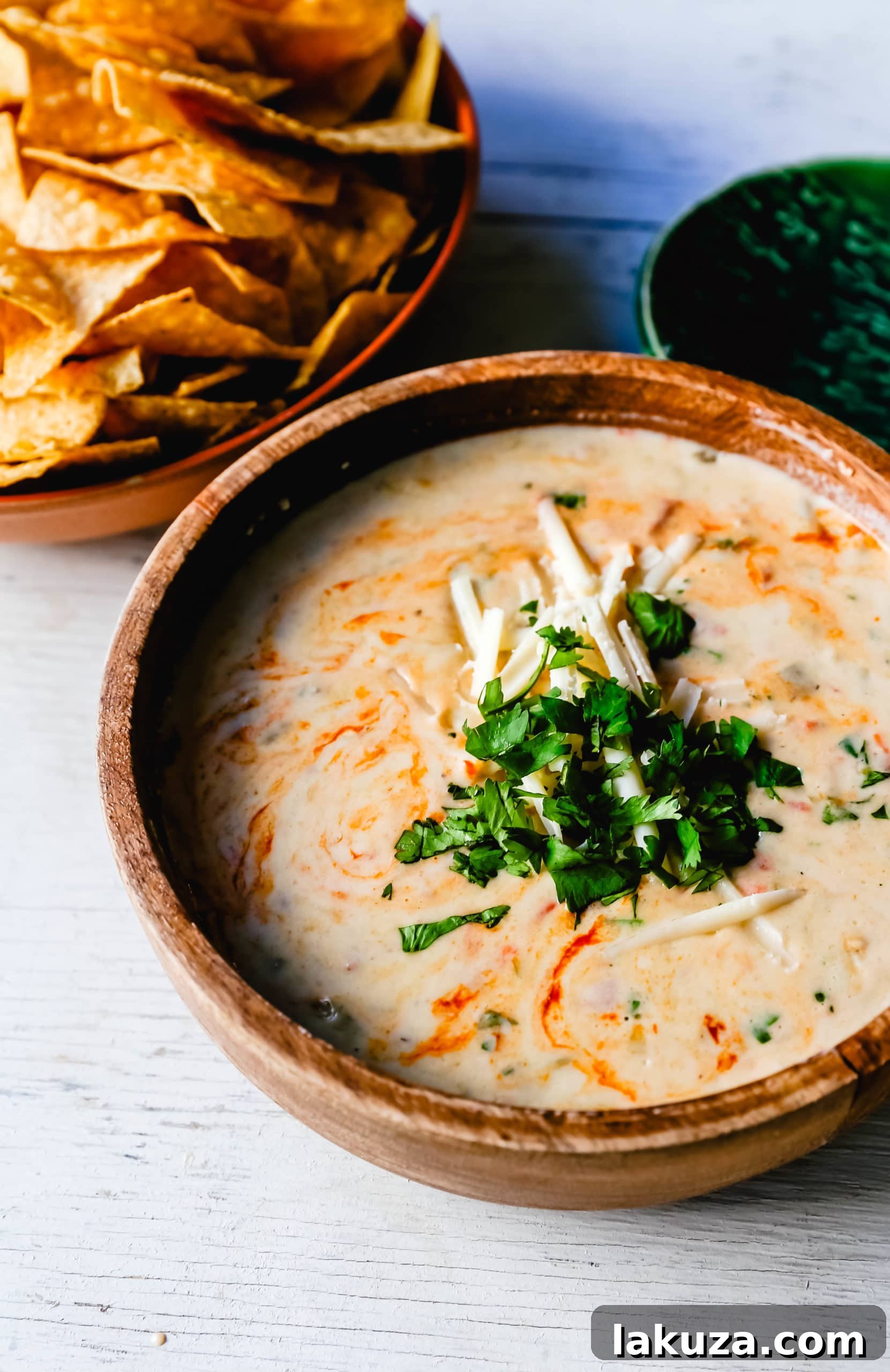 The ultimate creamy green chile queso blanco dip, featuring a harmonious blend of high-quality cheeses, diced green chiles, fresh cilantro, and a dash of hot sauce for the perfect kick. Learn secrets to making the best homemade queso dip every time! #queso #mexicanfood #cheesedip #appetizerideas