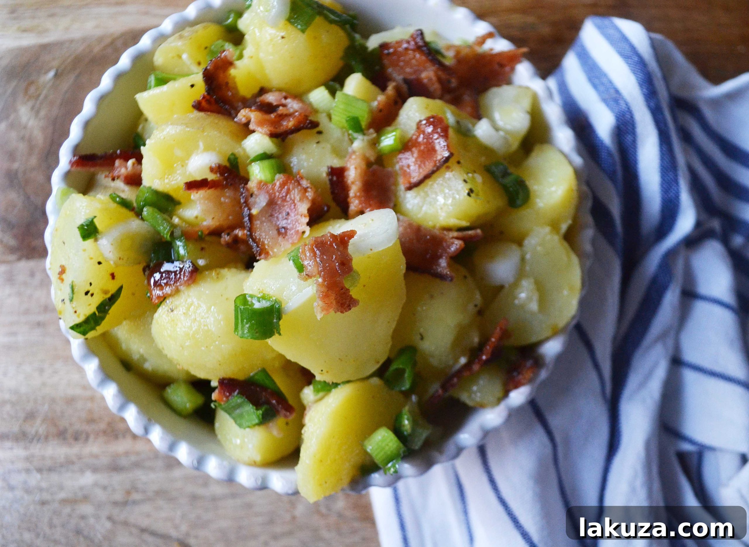 Potato Salad Reimagined 4 Light and Fresh German Potato Salad with olive oil and vinegar, topped with bacon and green onions. A mayo-free potato salad recipe. Modern Honey.