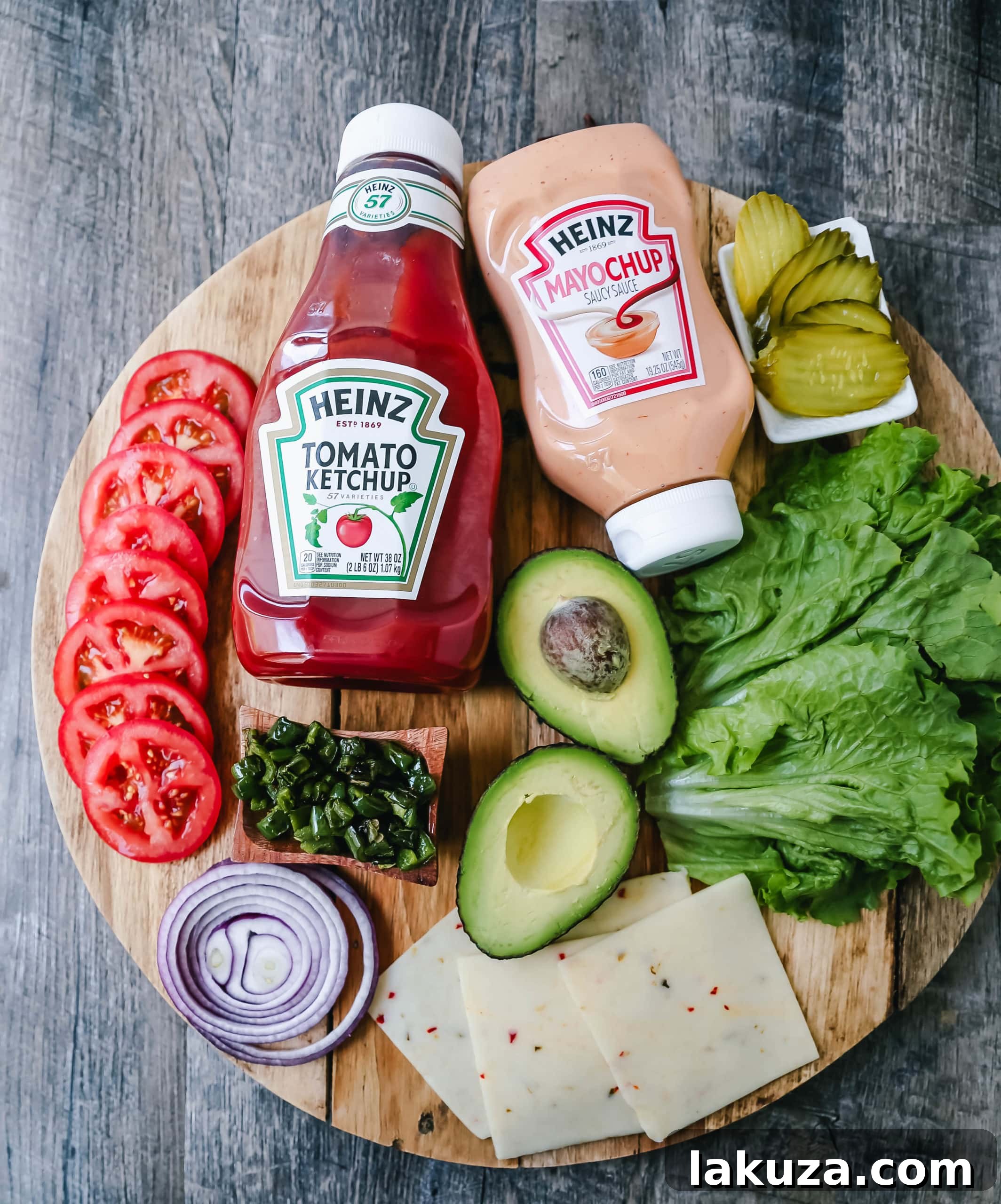 A vibrant platter showcasing an array of fresh burger toppings, including cheeses, vegetables, and sauces.