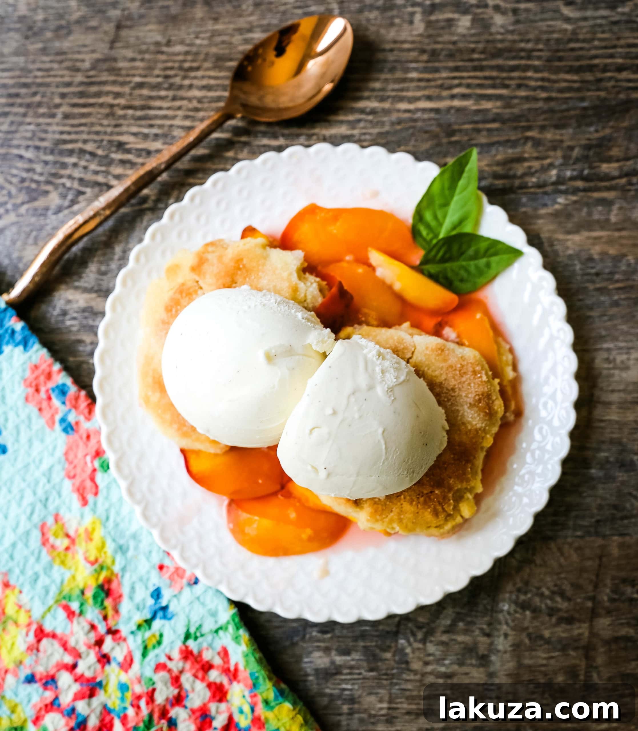 Perfectly baked Peach Cobbler, golden brown topping with bubbly peach filling.
