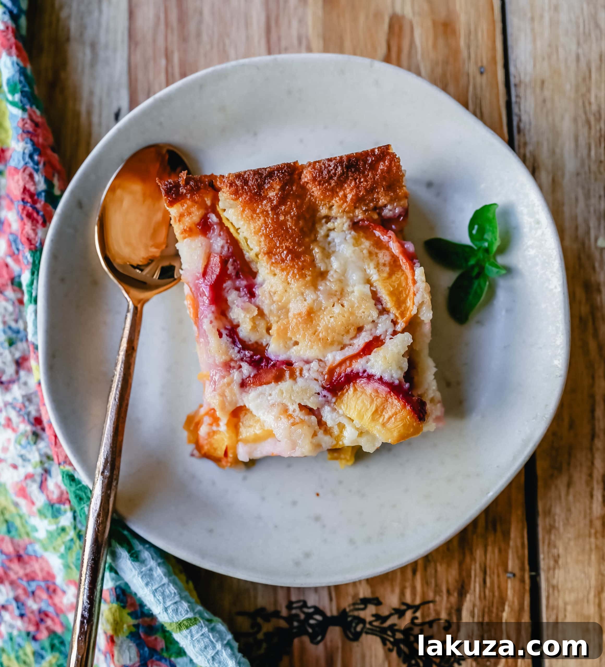 Close-up of Texas peach cobbler, showcasing the tender peaches and the golden, bubbly cake-like crust.