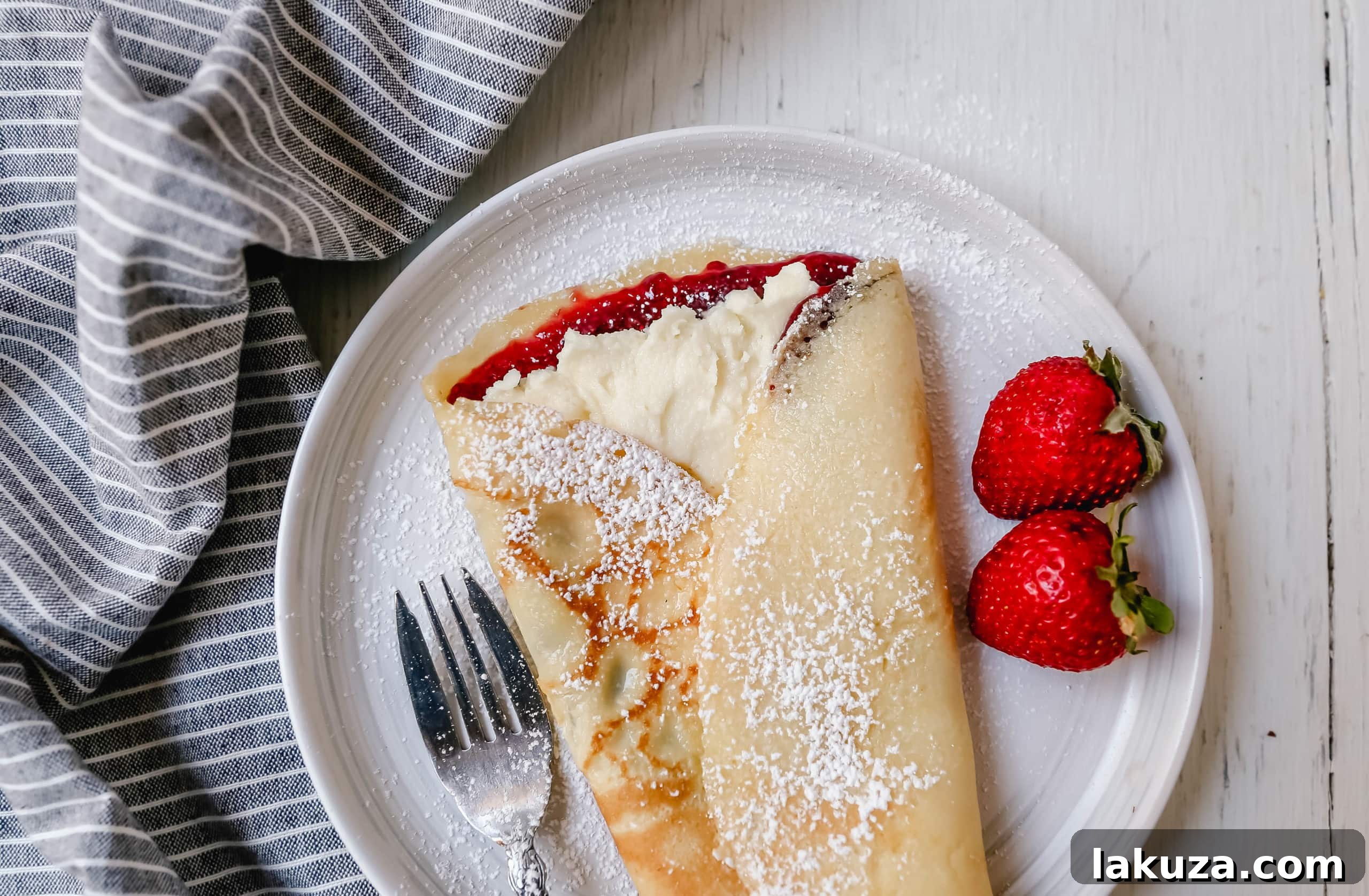 Crepe batter being swirled in a non-stick pan to create a thin, even layer.